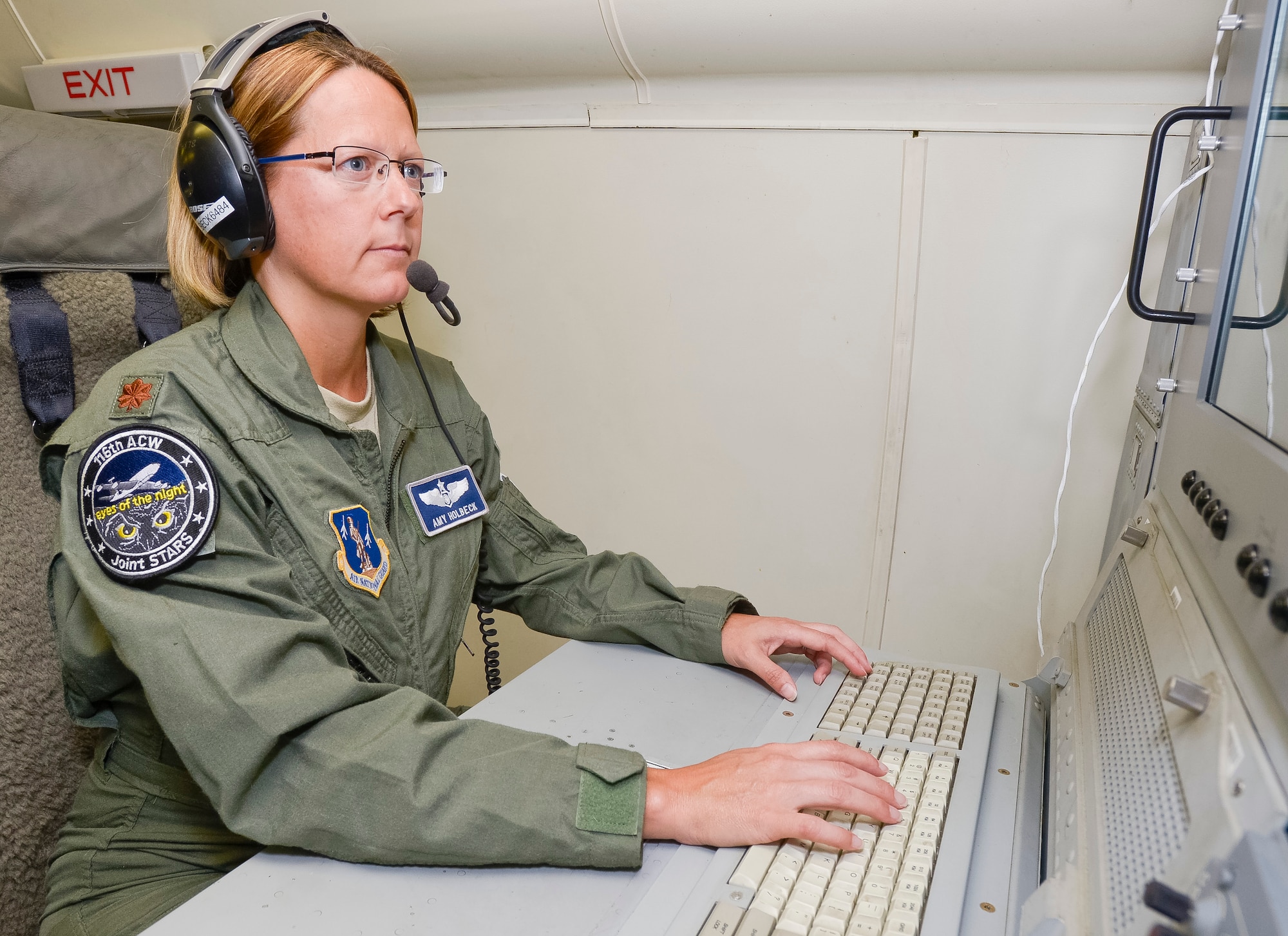 U.S. Air Force Maj. Amy Holbeck, an aviator with the 116th Air Control Wing, Georgia Air National Guard, monitors a computer screen from an operator workstation aboard an E-8C Joint STARS, Robins Air Force Base, Ga., Oct. 11, 2013. Holbeck recently won the Lance P. Sijan award at the Air National Guard level in the senior officer category. (U.S. Air National Guard photo by Master Sgt. Roger Parsons/Released)