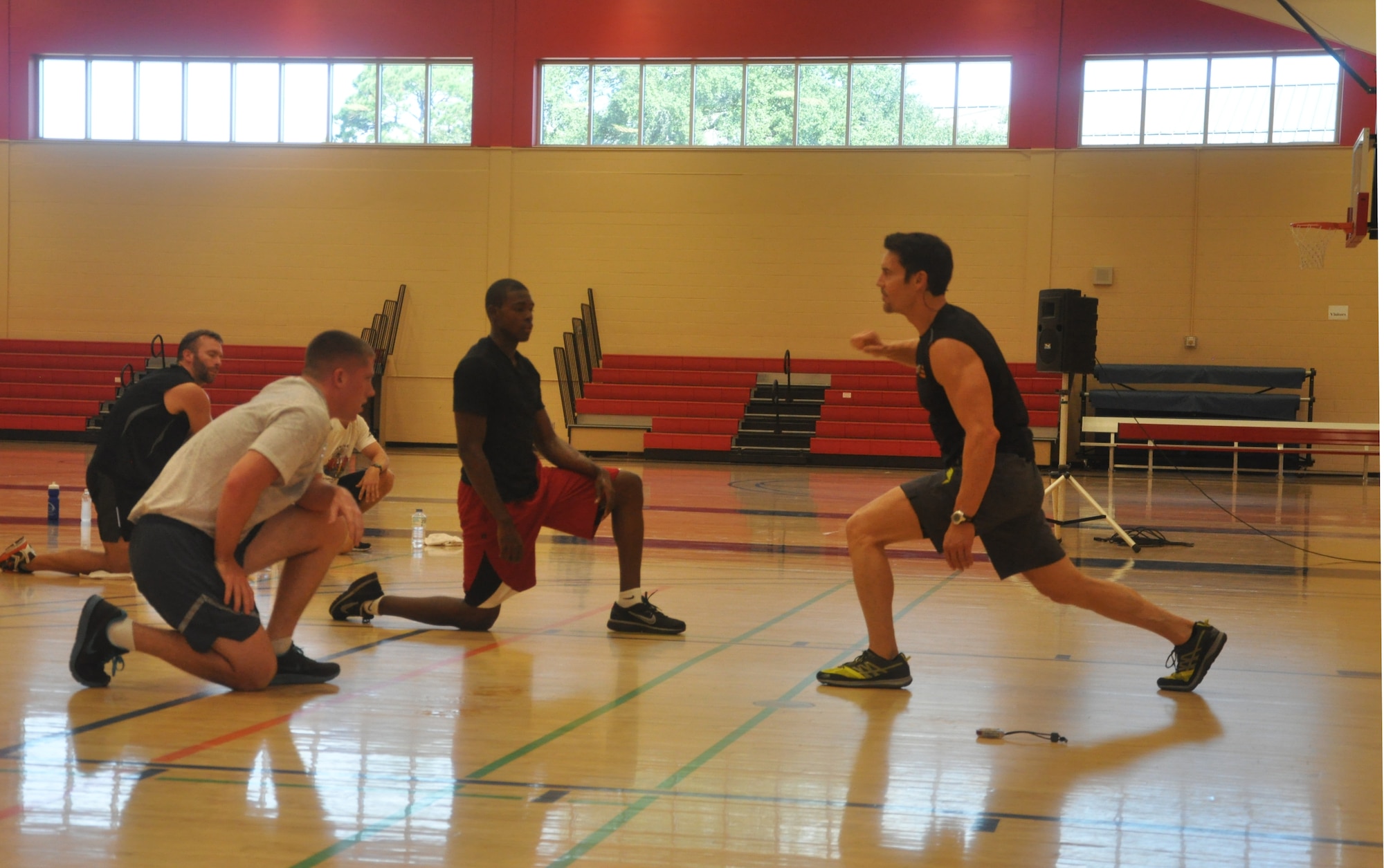 Tony Horton, P90X creator, demonstrates an exercise during his “Warrior Tough Workout” in Tyndall’s Fitness Center Oct. 15. Mr. Horton spent the day working out with Airmen while mentoring them on how they can reach their fitness goals. (U.S. Air Force photo by Airman 1st Class Alex Echols)