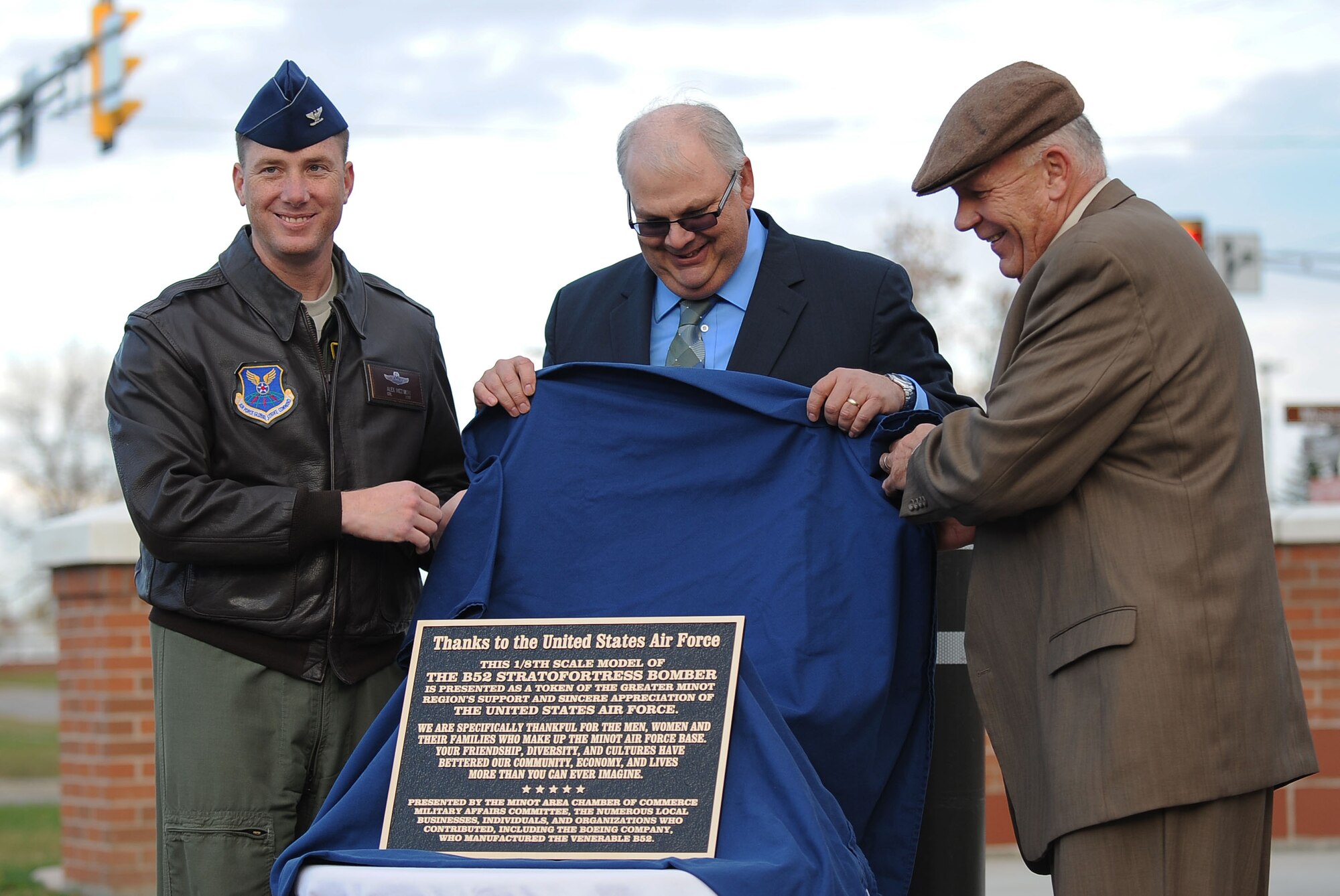 5th Bomb Wing Commander, Col. Alex Mezynski, was joined by Bruce Carlson, Military Affairs Committee Chairman, and Scot Oathout, Boeing B-52 and Legacy Tanker Program Manager, at the unveiling of the B-52H Stratofortress static display in front of the 5th BW headquarters building at Minot Air Force Base, N.D., Oct. 17. The static display is a tribute to the mighty aircraft of the 5th BW.  (U.S. Air Force photo/Airman 1st Class Lauren Pitts)