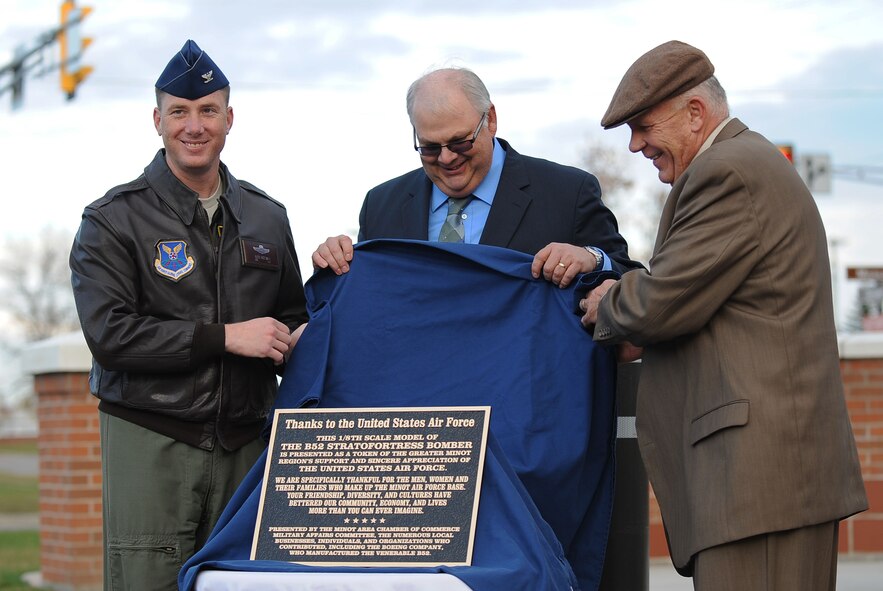 5th Bomb Wing Commander, Col. Alex Mezynski, was joined by Bruce Carlson, Military Affairs Committee Chairman, and Scot Oathout, Boeing B-52 and Legacy Tanker Program Manager, at the unveiling of the B-52H Stratofortress static display in front of the 5th BW headquarters building at Minot Air Force Base, N.D., Oct. 17. The static display is a tribute to the mighty aircraft of the 5th BW.  (U.S. Air Force photo/Airman 1st Class Lauren Pitts)