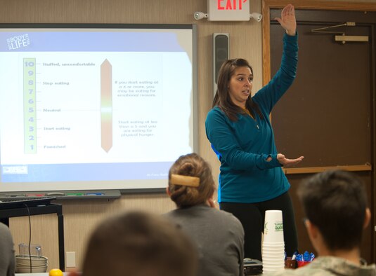 Abby Olson, 28th Medical Operations registered dietitian, informs attendees of the Better Body Better Life class about controlling the amount of food they consume in the Health and Wellness Center at Ellsworth Air Force Base, S.D., Oct. 10, 2013. The BBBL course teaches Airmen, families and civilians how to better themselves through nutrition and fitness, combining one hour of diet education and one hour of exercise. (U.S. Air Force photo by Airman 1st Class Alystria Maurer/Released)