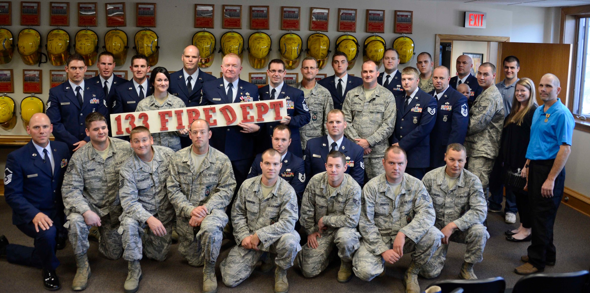 The remaining members of the 133rd Fire Department pose for one final group photo after the closing ceremony for the crew.  (U.S. Air National Guard photo by Tech. Sgt. Lynette Olivares/ Released) 