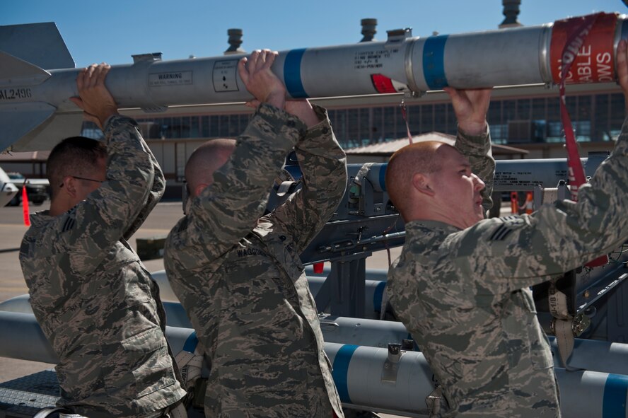 An F-22 Raptor aircraft load crew unloads an inert missile during a quarterly load-crew competition at Holloman Air Force Base, N.M., Oct. 11. The F-22 Raptor load crew competed to have their skills evaluated alongside MQ-9 Reaper and German Air Force Tornado load crews. For the competition, points were awarded for weapons loading, tool kit inspection and uniform inspection. (U.S. Air Force photo by Airman 1st Class Aaron Montoya/Released)