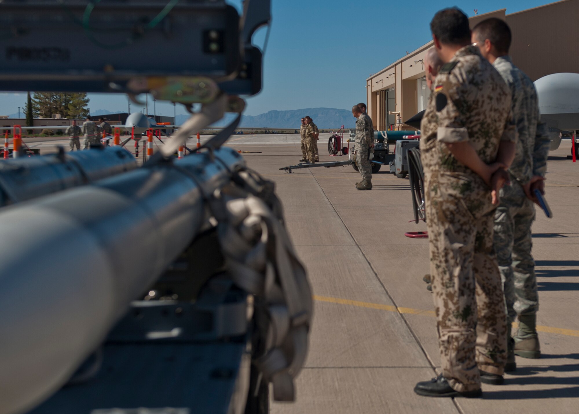 Airmen from the U.S. Air Force and the German Air Force await the start of this quarterly load-crew competition at Holloman Air Force Base, N.M., Oct. 11. The GAF Flying Training Center competed to have their skills evaluated alongside U.S. Air Force F-22 Raptor and MQ-9 Reaper load crews. For the competition, points were awarded for weapons loading, tool kit inspection and uniform inspection. (U.S. Air Force photo by Airman 1st Class Aaron Montoya/Released)