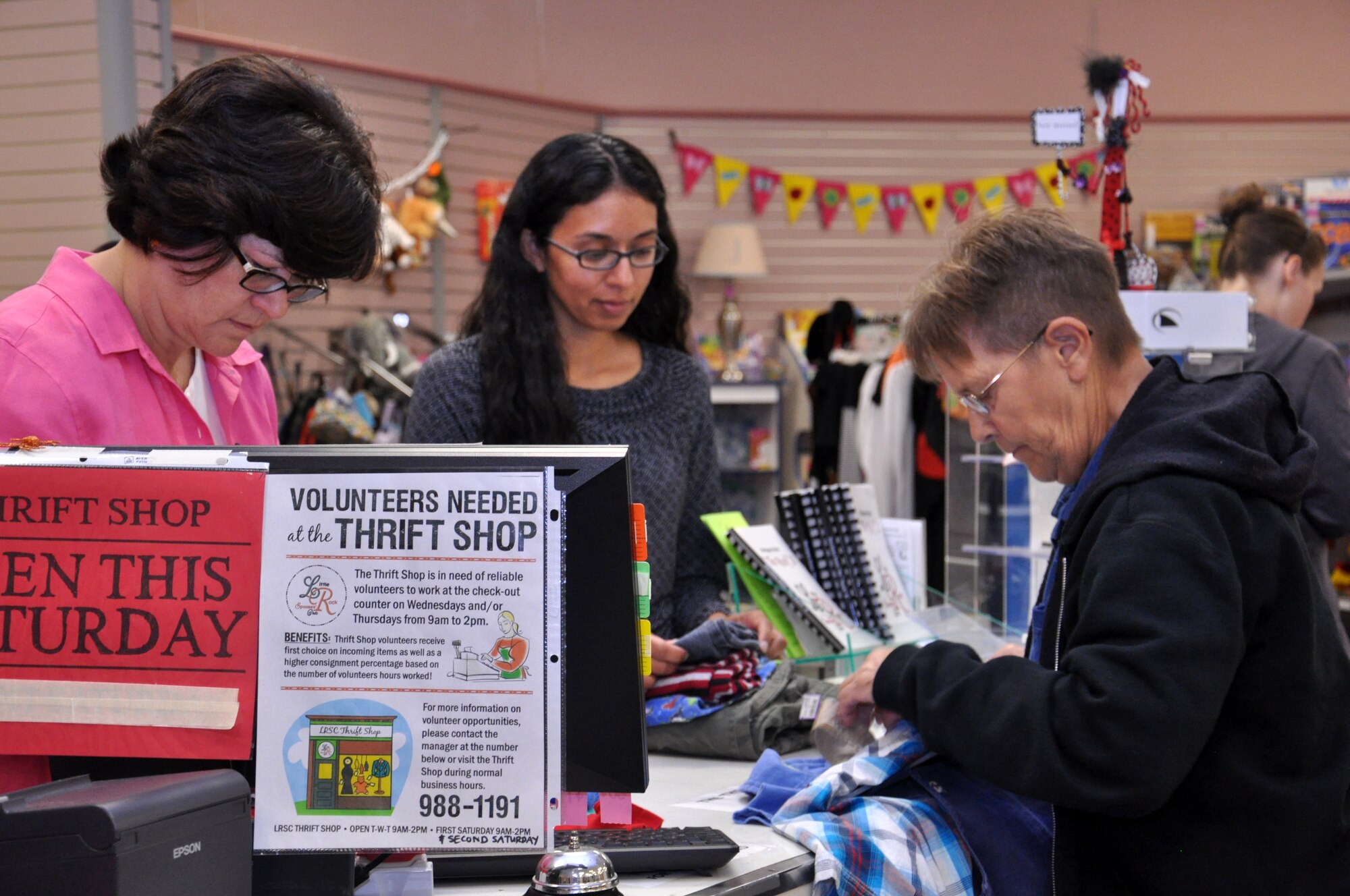 Carol Jeter, Thrift Shop volunteer, and Naomi Taylor, Thrift Shop manager, assist a customer Oct. 8, 2013, at Little Rock Air Force Base, Ark. The shop is open Tuesday, Wednesday, Thursday and every second Saturday of the month from 9 a.m. – 2 p.m. (U.S. Air Force photo by Senior Airman Regina Agoha)
