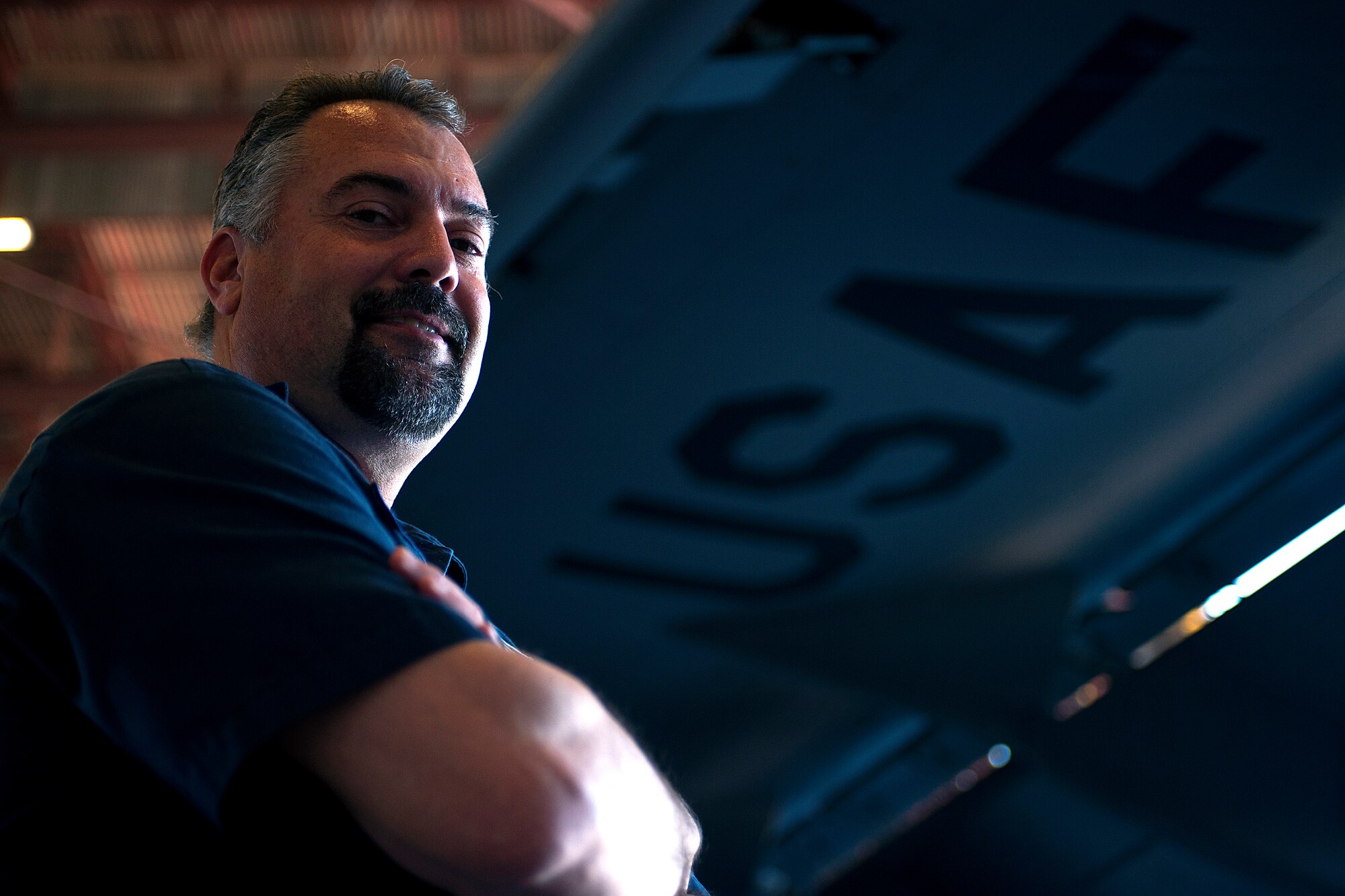 ALTUS AIR FORCE BASE, Okla. – John Kneisel, 97th Air Mobility Wing Maintenance Division A-Team member, stands under the wing of a C-17 Globemaster III cargo aircraft during a 720-day home station refurbishing Oct. 10, 2013. Periodically, this inspection occurs to ensure the aircraft is operationally ready by cleaning and refurbishing unserviceable and malfunctioning system and structural components. Panel removal and recalibration of the seats, airdrop systems and cleaning of inner floor panels account for a most of the restoration. (U.S. Air Force photo by Senior Airman Jesse Lopez/Released)