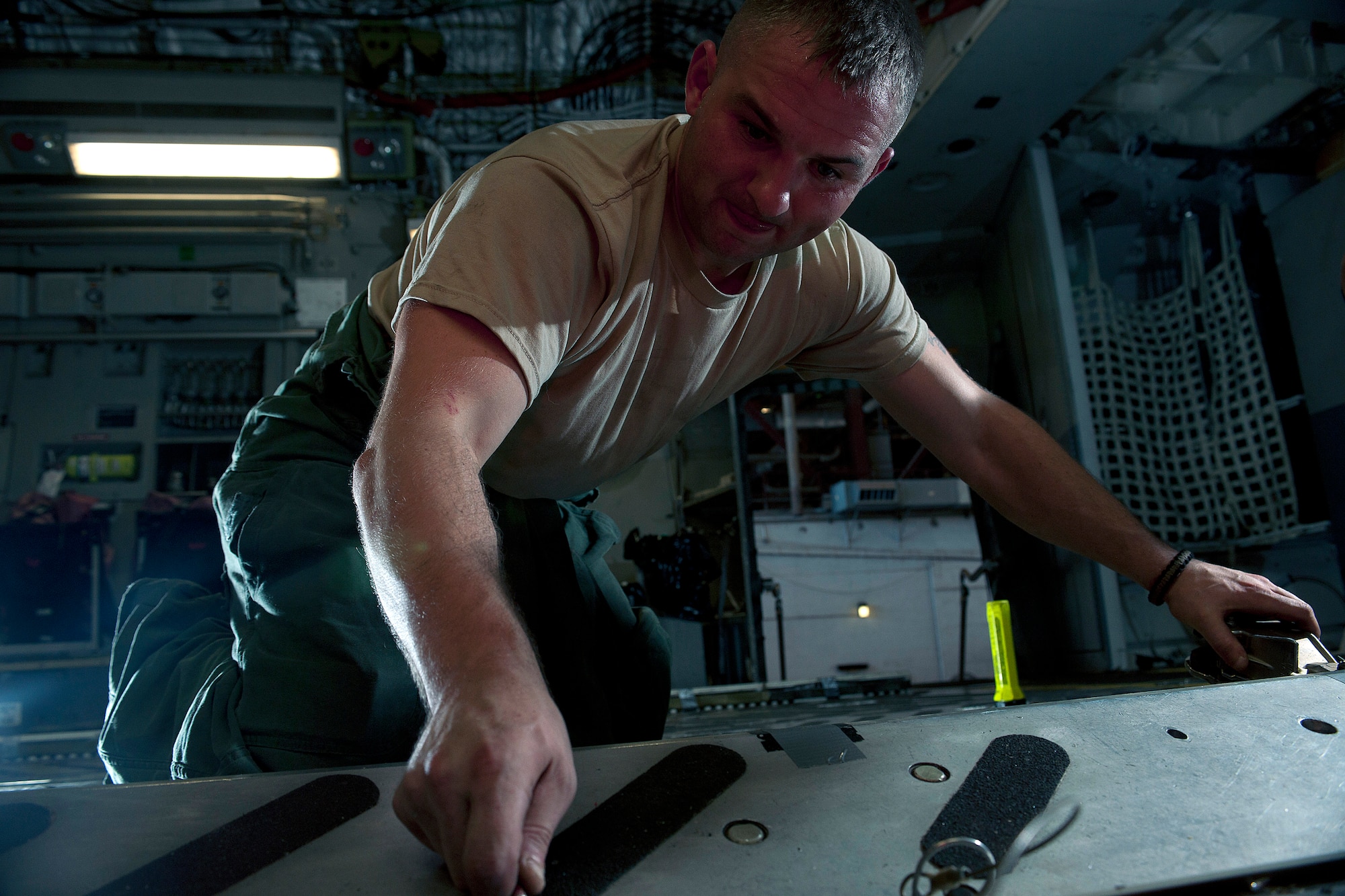 ALTUS AIR FORCE BASE, Okla. – Senior Airman James Kelleher, 97th Air Mobility Wing Maintenance Division crew chief, removes the airdrop railings of a C-17 Globemaster III cargo aircraft during a 720-day home station refurbishing Oct. 10, 2013. The aircraft’s make-over consists of inspection and restoration of components vital to keeping the aircraft mission ready. (U.S. Air Force photo by Senior Airman Jesse Lopez/Released)