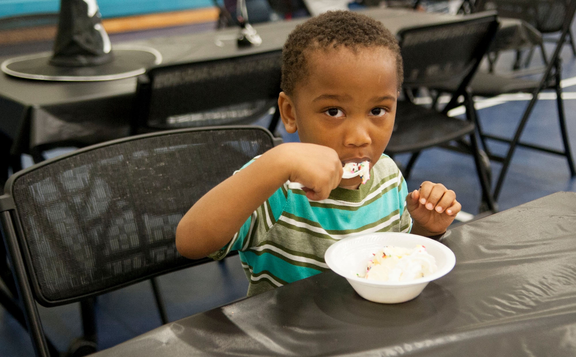 Zaire Harrison, son of U.S. Air Force Staff Sgt. Shaneka Harrison and Tech. Sgt. Muhammad Harris, enjoys ice cream at a Deployed Families’ Ice Cream social at Moody Air Force Base, Ga., Oct. 15, 2013. The event featured an ice cream bar, games, a raffle, family portraits and a bounce house. (U.S. Air Force photo by Airman 1st Class Sandra Marrero/Released)
