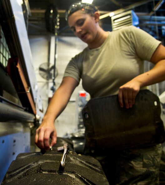 Airman 1st Class Johanna Desimone, 5th Logistics Readiness Squadron vehicle maintainer, puts the side panel on a loader at Minot Air Force Base, N.D., Oct. 16, 2013. The 5th LRS vehicle maintenance flight repairs and maintains various types of vehicles to ensure Minot AFB stays mobile. (U.S. Air Force photo/Senior Airman Brittany Y. Auld)