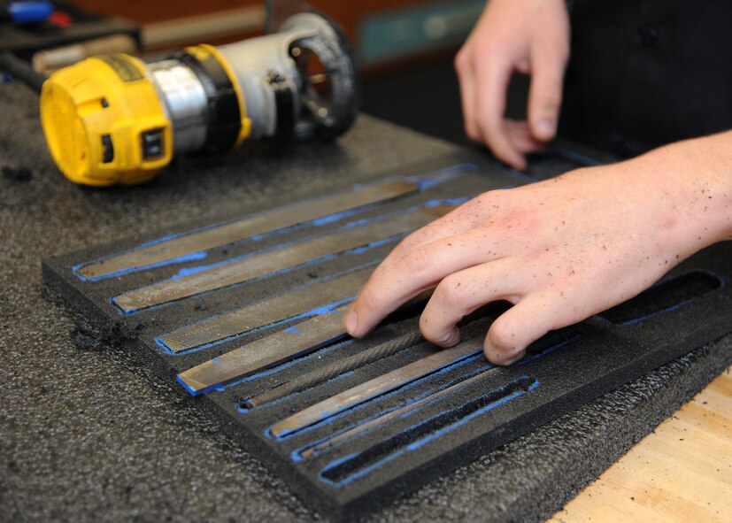 Airman 1st Class Daniel Ward, 2nd Logistics Readiness Squadron vehicle mechanic, places a file into a foam cutout on Barksdale Air Force Base, La., Oct. 17, 2013. Ward used a router to cut out various sized shapes into a piece of foam. 2nd LRS has more than 30 toolboxes containing more than 450 tools each.  (U.S. Air Force photo/Senior Airman Joseph A. Pagán Jr.)