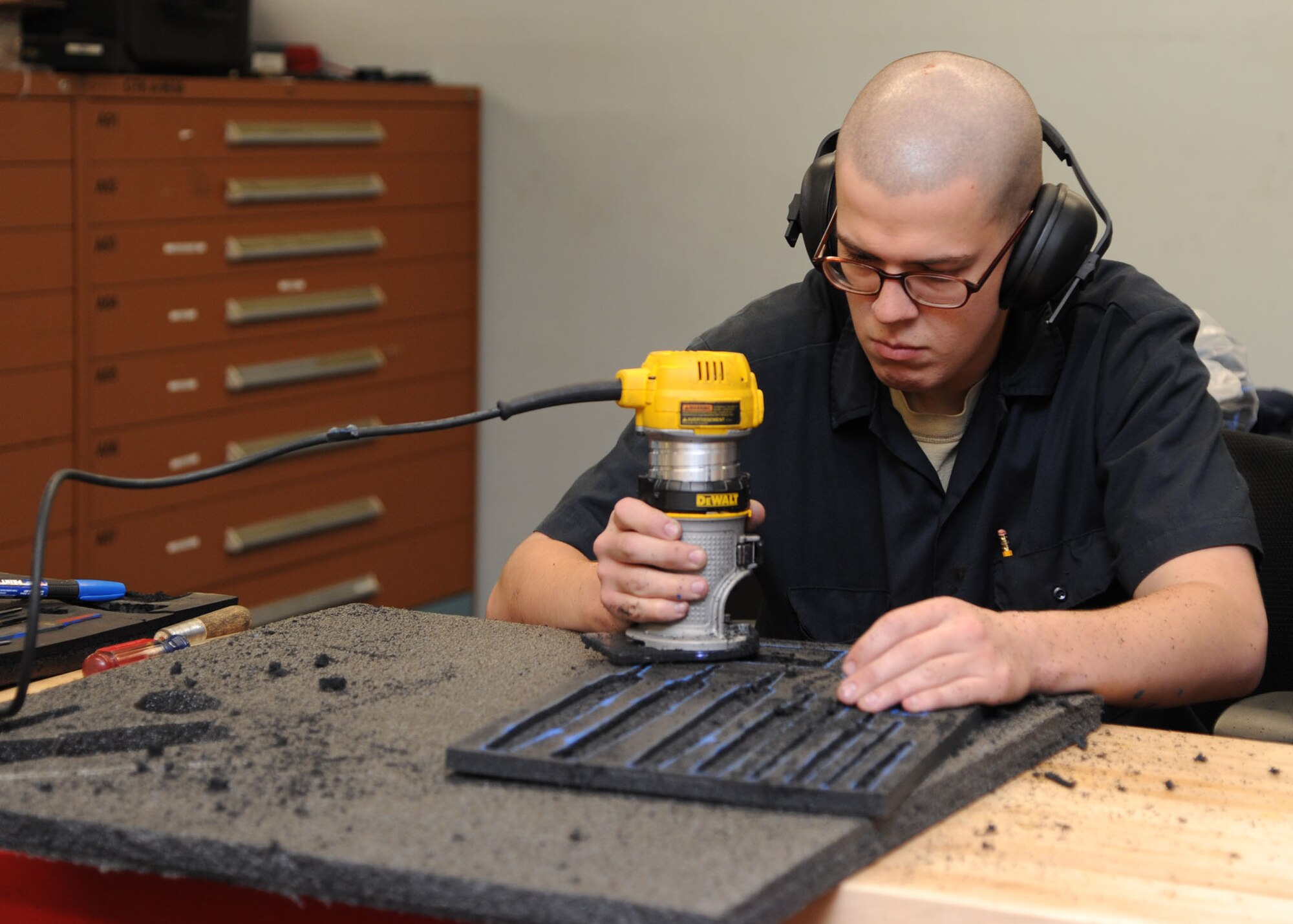 Airman 1st Class Daniel Ward, 2nd Logistics Readiness Squadron vehicle mechanic, uses a router to remove foam cutouts on Barksdale Air Force Base, La., Oct. 17, 2013. Foam cutouts in toolboxes keep all tools accounted for, preventing foreign object debris and having to repurchase tools. (U.S. Air Force photo/Senior Airman Joseph A. Pagán Jr.)