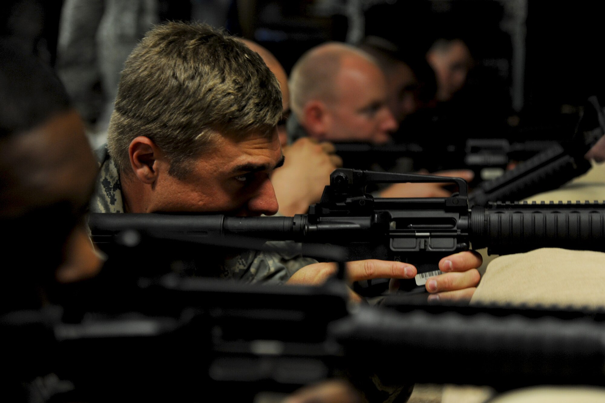 U.S. Air Force Airmen from the 633rd Civil Engineer Squadron Prime Base Emergency Engineer Force (BEEF) practice firing during a simulated live-fire training sessions at Fort Eustis, Va., Oct. 16, 2013. Utilizing a simulated firing range eliminates the need for real ammo, saving time and money. (U.S. Air Force photo by Airman 1st Class Austin Harvill/Released)