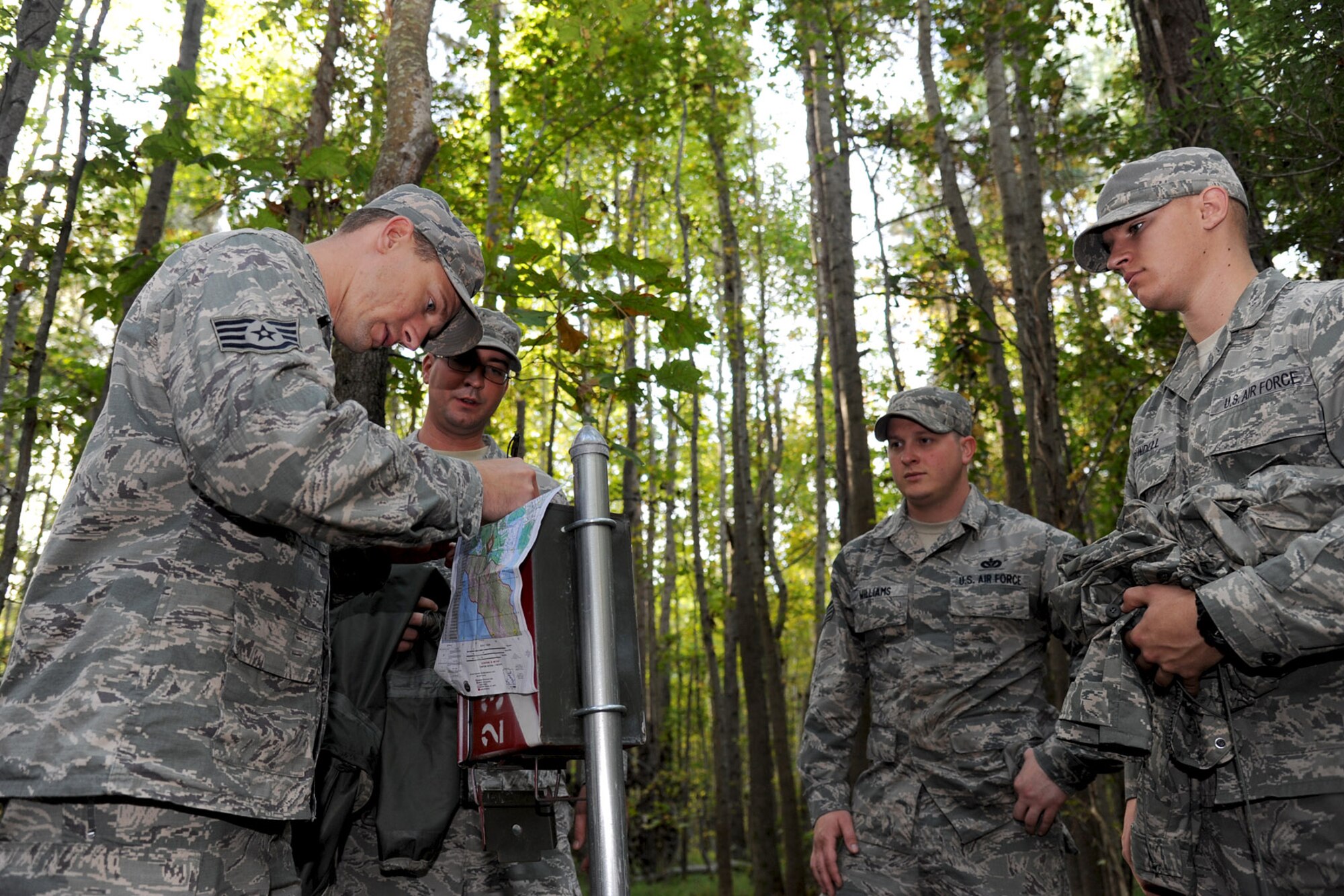 U.S. Air Force Airmen from the 633rd Civil Engineer Squadron Prime Base Emergency Engineer Force (BEEF) discover a marker during land navigation training at Fort Eustis, Va., Oct. 16, 2013. Airmen utilized a Fort Eustis training area designated for land navigation exclusively. (U.S. Air Force photo by Airman 1st Class Austin Harvill/Released)