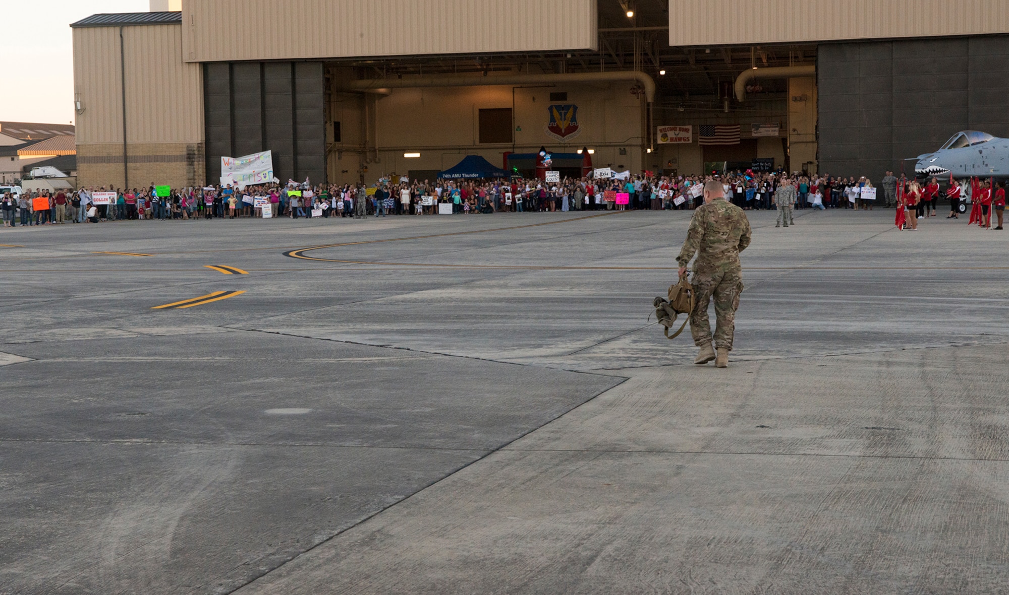 A single Airman walks toward a welcoming crowd at Moody Air Force Base, Ga., Oct. 9, 2013. More than 300 Airmen returned from a six-month deployment to reunite with friends and family. (U.S. Air Force photo by Airman 1st Class Ryan Callaghan/Released)
