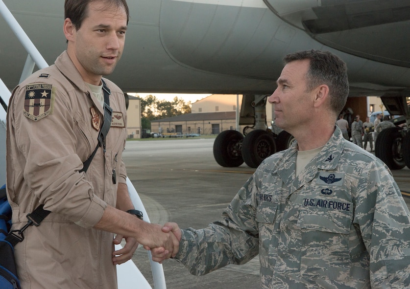 U.S Air Force Capt. Aaron Bohn, left, 76th Fighter Squadron A-10C Thunderbird II pilot, shakes hands with Col. Chad Franks, 23d Wing commander, at Moody Air Force Base, Ga., Oct. 9, 2013.Commanders, vice commanders and distinguished visitors welcomed redeploying Airmen with handshakes as they left the aircraft. (U.S. Air Force photo by Airman 1st Class Ryan Callaghan/Released)
