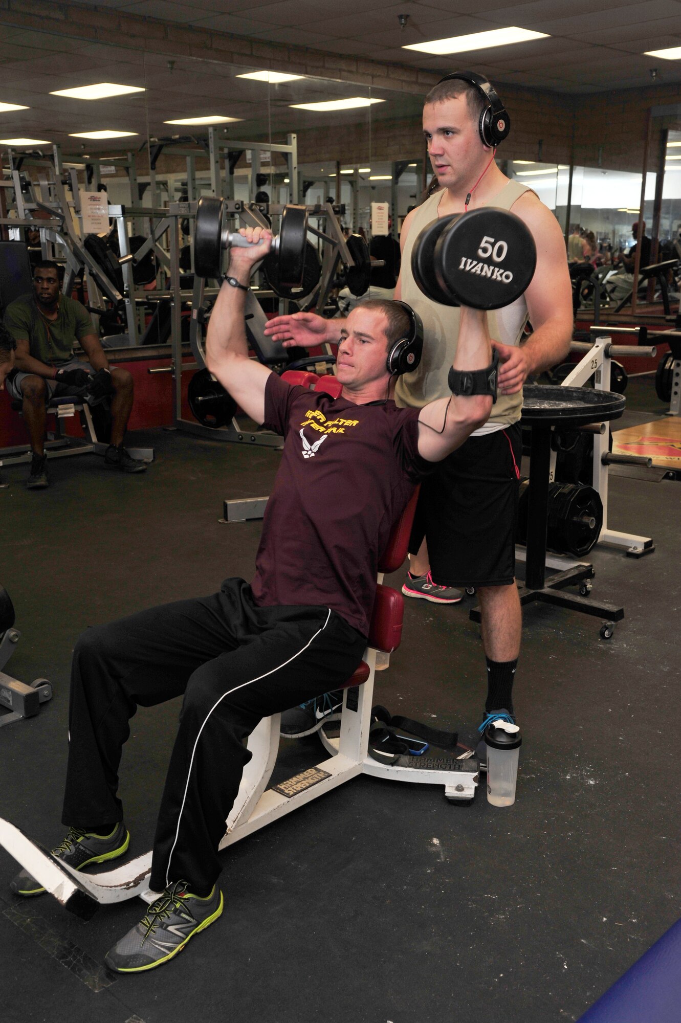 Airman 1st Class Kory Hickok, 310th Aircraft Maintenance Unit weapons load crew member, spots Staff Sgt. Kris Steele, who is also a weapons load crew member, Oct. 8 at the Luke Air Force Base Bryant Fitness Center. Staying active is key to lowering the likelihood of diseases such as diabetes, high blood pressure and high cholesterol. 
 (U.S. Air Force photo/Senior Airman Grace Lee)