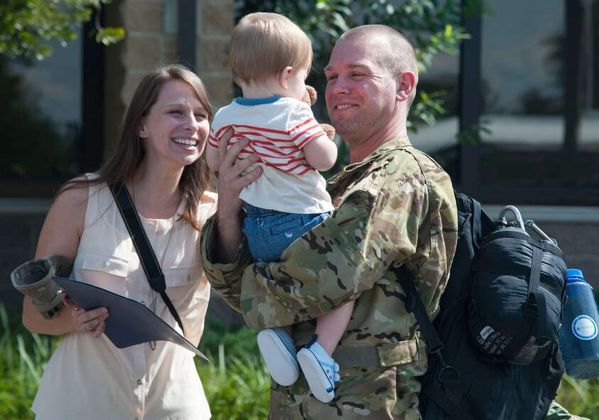 U.S. Air Force Capt. Michael S. Welt, 41st Rescue Squadron, hugs his son at Moody Air Force Base, Ga., Oct. 13, 2013. The 41st RQS returned from Camp Bastion, Afghanistan after a six-month deployment. (U.S. Air Force photo by Airman Dillian Bamman/Released)