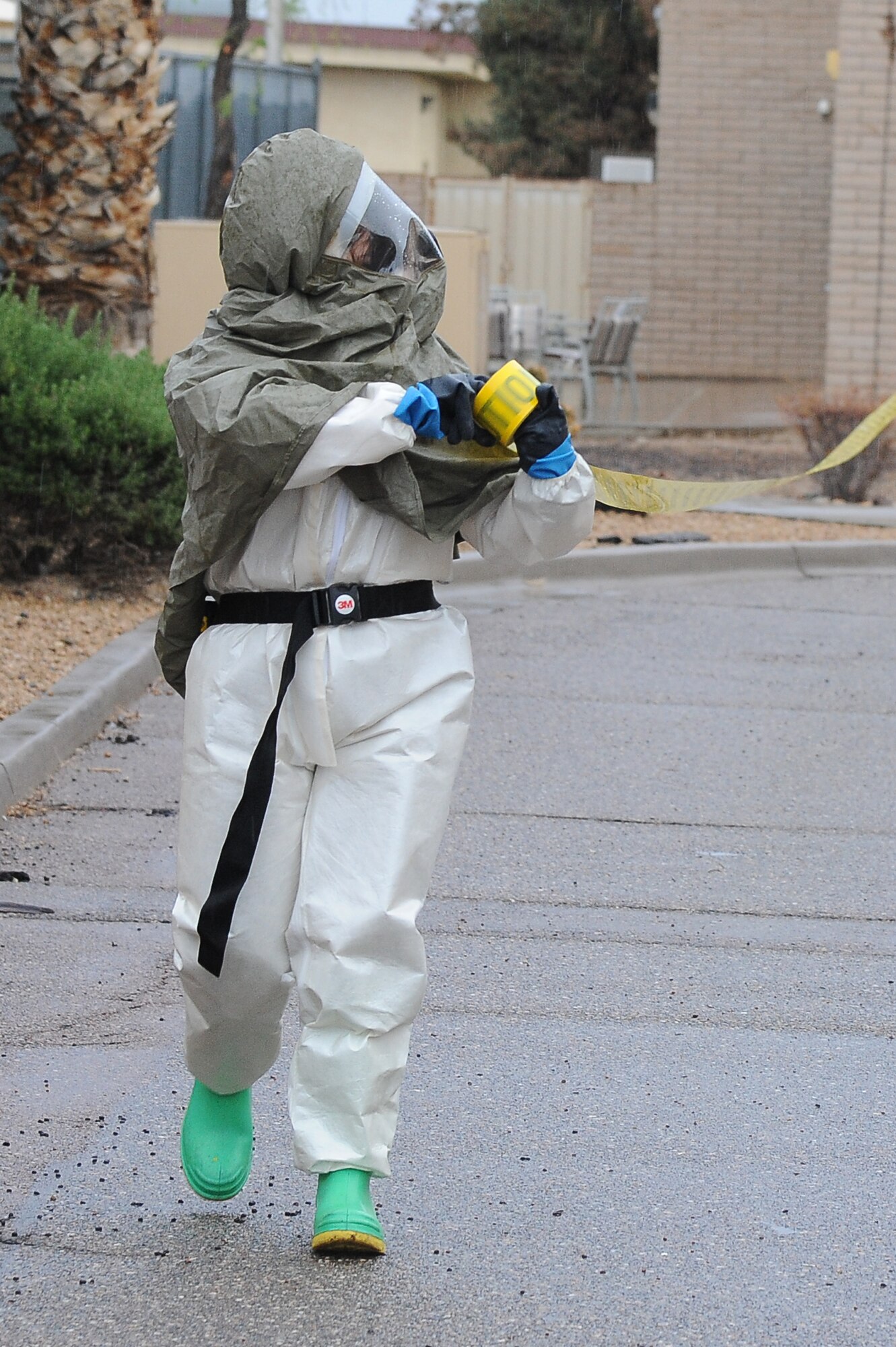 An MDOS member sets up a cordon to keep people away during the exercise. The exercise was held to evaluate 56th MDOS members’ ability to respond in a timely manner to a nerve agent release or, in this case, pesticide. (U.S. Air Force photo/Airman 1st Class James Hensley)