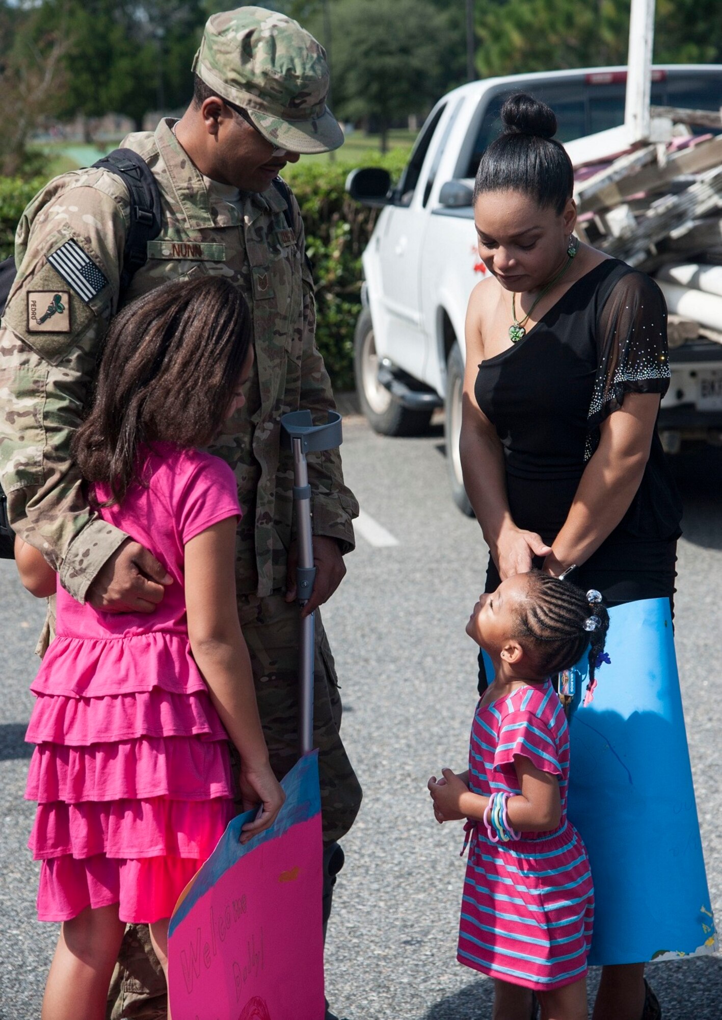 U.S. Air Force Tech. Sgt. Calvin Nunn Jr., 23d Aircraft Maintenance Squadron crew chief reunites with his wife and children at Moody Air Force Base, Ga., Oct. 13, 2013. The 723d AMXS maintains Moody’s A-10C Thunderbolt IIs and prepares them for the mission. (U.S. Air Force photo by Airman Dillian Bamman/Released)