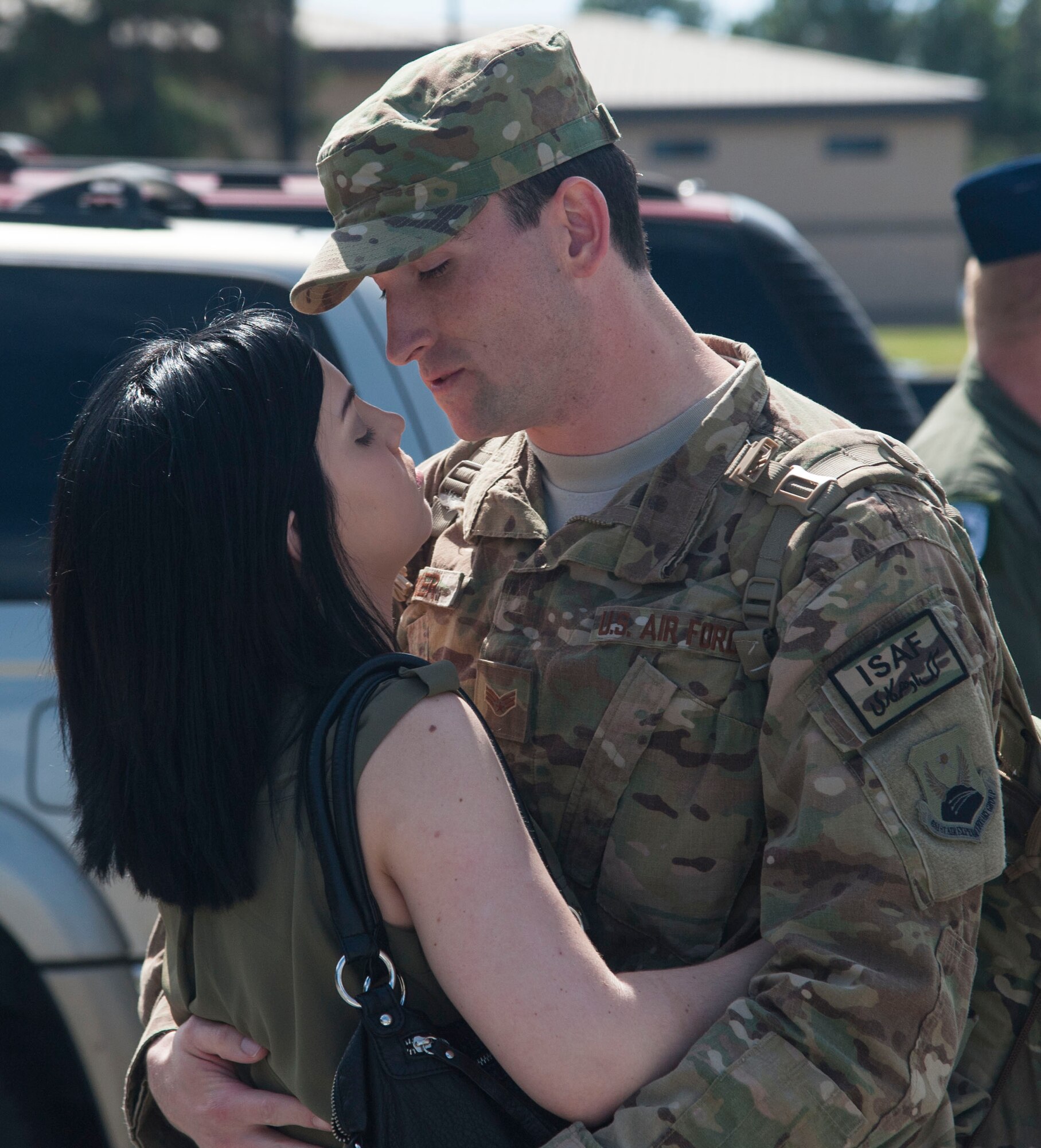 U.S. Air Force Senior Airman Richard G. Walker, 723d Aircraft Maintenance Squadron crew member hugs his wife for the first time in six months on Moody Air Force Base, Ga., Oct. 13, 2013. Walker deployed with Airmen from the 23d Maintenance Group and 347th Rescue Group. (U.S. Air Force photo by Airman Dillian Bamman/Released)