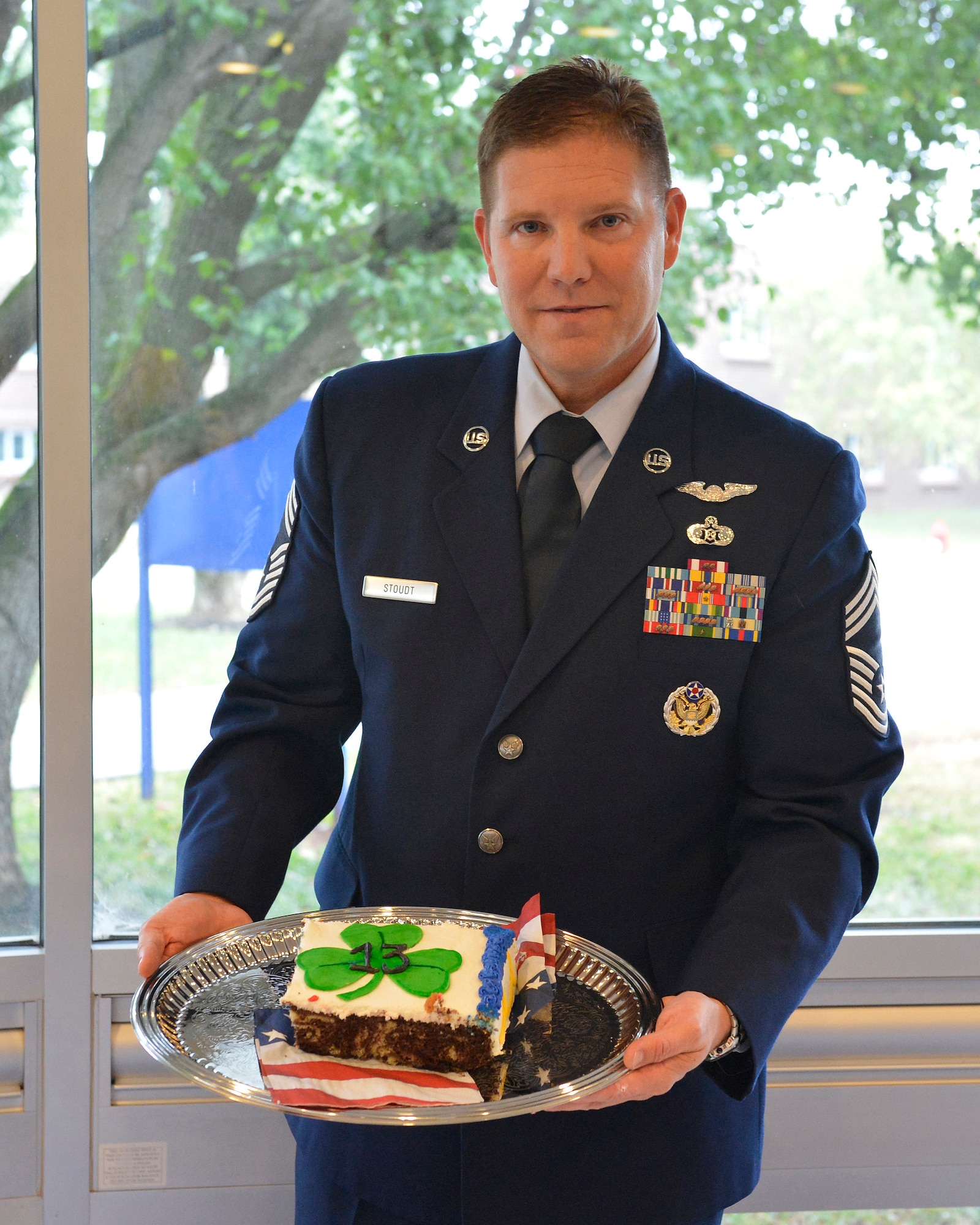 Chief Master Sgt. Thomas K. Stoudt, 13th commandant of the Paul H. Lankford Enlisted Professional Military Education Center here, holds a section of his change of commandant cake Oct. 17 on the I.G. Brown Training and Education Center campus at Spruance Hall. (U.S. Air National Guard photo by Master Sgt. Kurt Skoglund/Released)