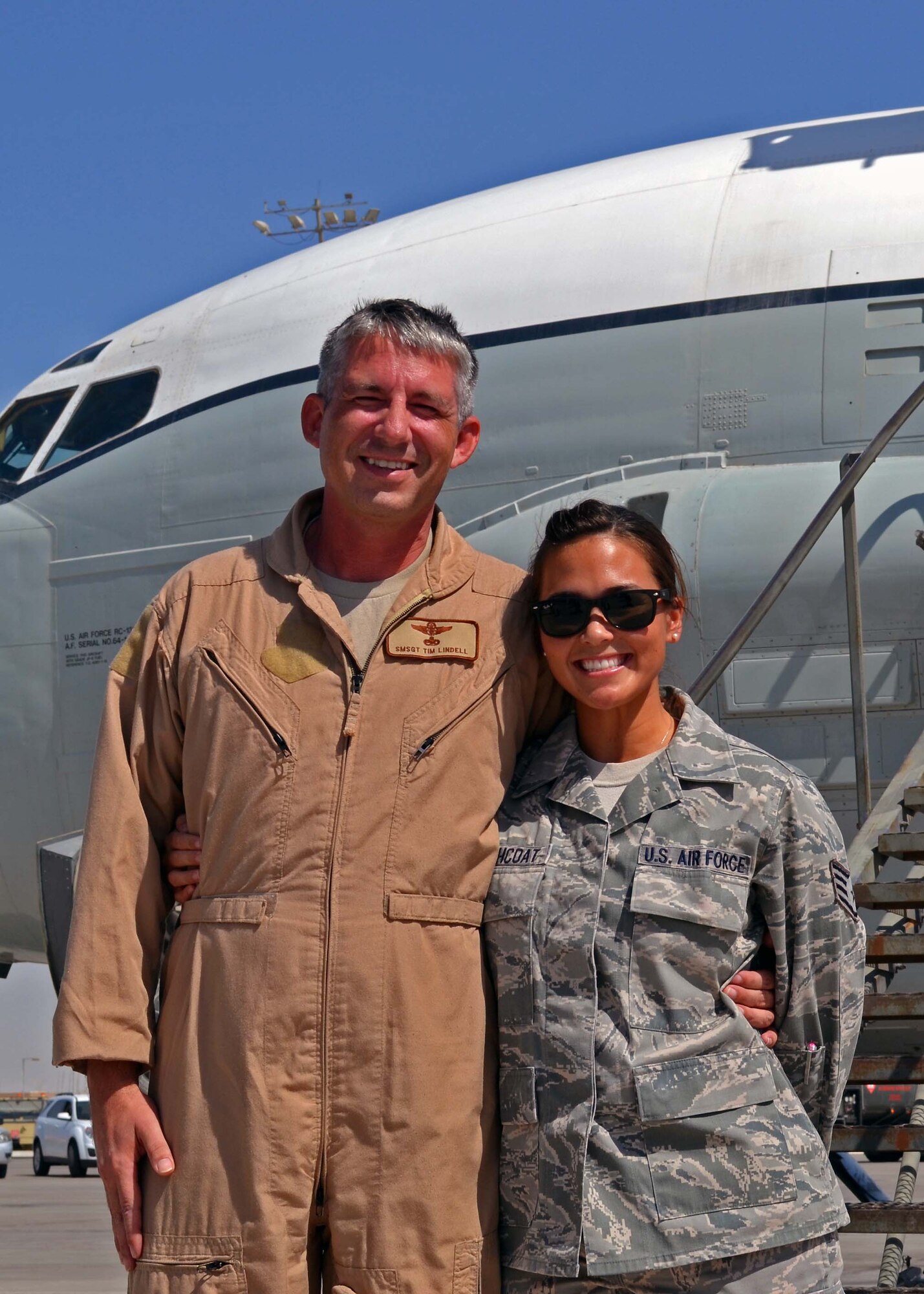Senior Master Sgt. Thomas Lindell and daughter, Staff Sgt. Kimberly Haithcoat, pose in front of an FC-135 Rivet Joint after his final flight aboard the aircraft at the 379th Air Expeditionary Wing in Southwest Asia, Oct. 10, 2013. Lindell and his daughter were both deployed at the same time and able to spend the last four months of his service in the Air Force together. Lindell is a 763rd Expeditionary Reconnaissance Squadron RC-135 systems engineer deployed from Offutt Air Force Base, Neb., and a Milbank, S.D., native. Haithcoat is an Air Forces Central Command knowledge operations manager deployed from Minot AFB, N.D., and a Bellevue, Neb., native. (U.S. Air Force photo/Capt. Robert Butler)
