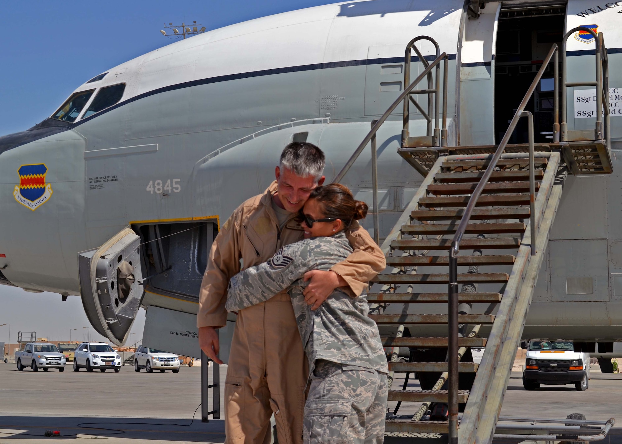 Senior Master Sgt. Thomas Lindell is met by his daughter, Staff Sgt. Kimberly Haithcoat, after his final flight aboard an RC-135 Rivet Joint at the 379th Air Expeditionary Wing in Southwest Asia, Oct. 10, 2013. Lindell and his daughter were both deployed at the same time and able to spend the last four months of his service in the Air Force together. Lindell is a 763rd Expeditionary Reconnaissance Squadron RC-135 systems engineer deployed from Offutt Air Force Base, Neb., and a Milbank, S.D., native. Haithcoat is an Air Forces Central Command knowledge operations manager deployed from Minot AFB, N.D., and a Bellevue, Neb., native. (U.S. Air Force photo/Capt. Robert Butler) 