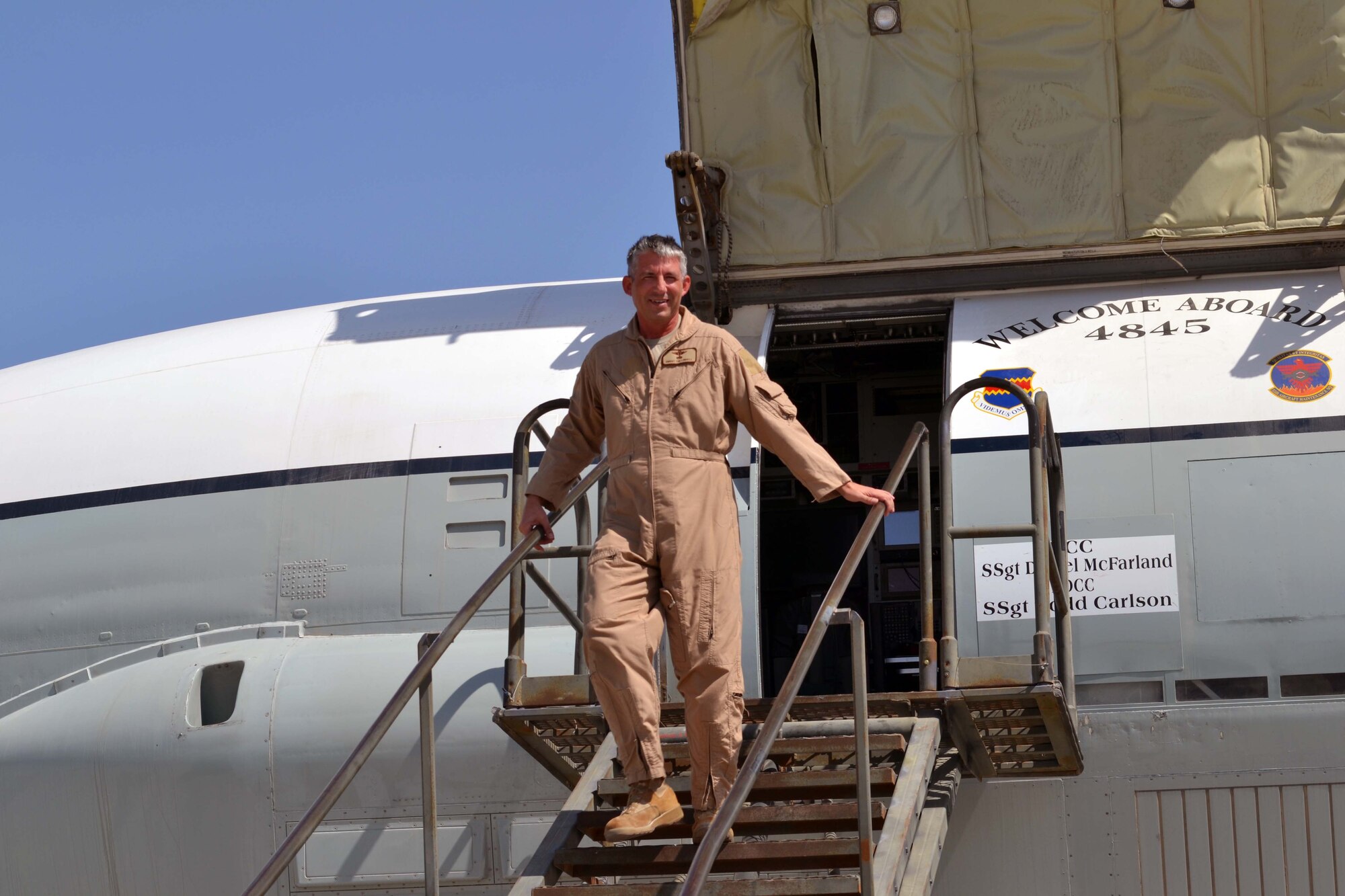 Senior Master Sgt. Thomas Lindell disembarks an RC-135B Rivet Joint for the last time after his final flight at the 379th Air Expeditionary Wing in Southwest Asia, Oct. 10, 2013. Lindell’s flight in service to his country occurred aboard the same RC-135 Rivet Joint aircraft that started his operational flying career nearly 20 years ago during Operation Provide Promise out of Bosnia. Lindell is a 763rd Expeditionary Reconnaissance Squadron RC-136 systems engineer deployed from Offutt Air Force Base, Neb., and a Milbank, S.D., native.  (U.S. Air Force photo/Capt. Robert Butler) 