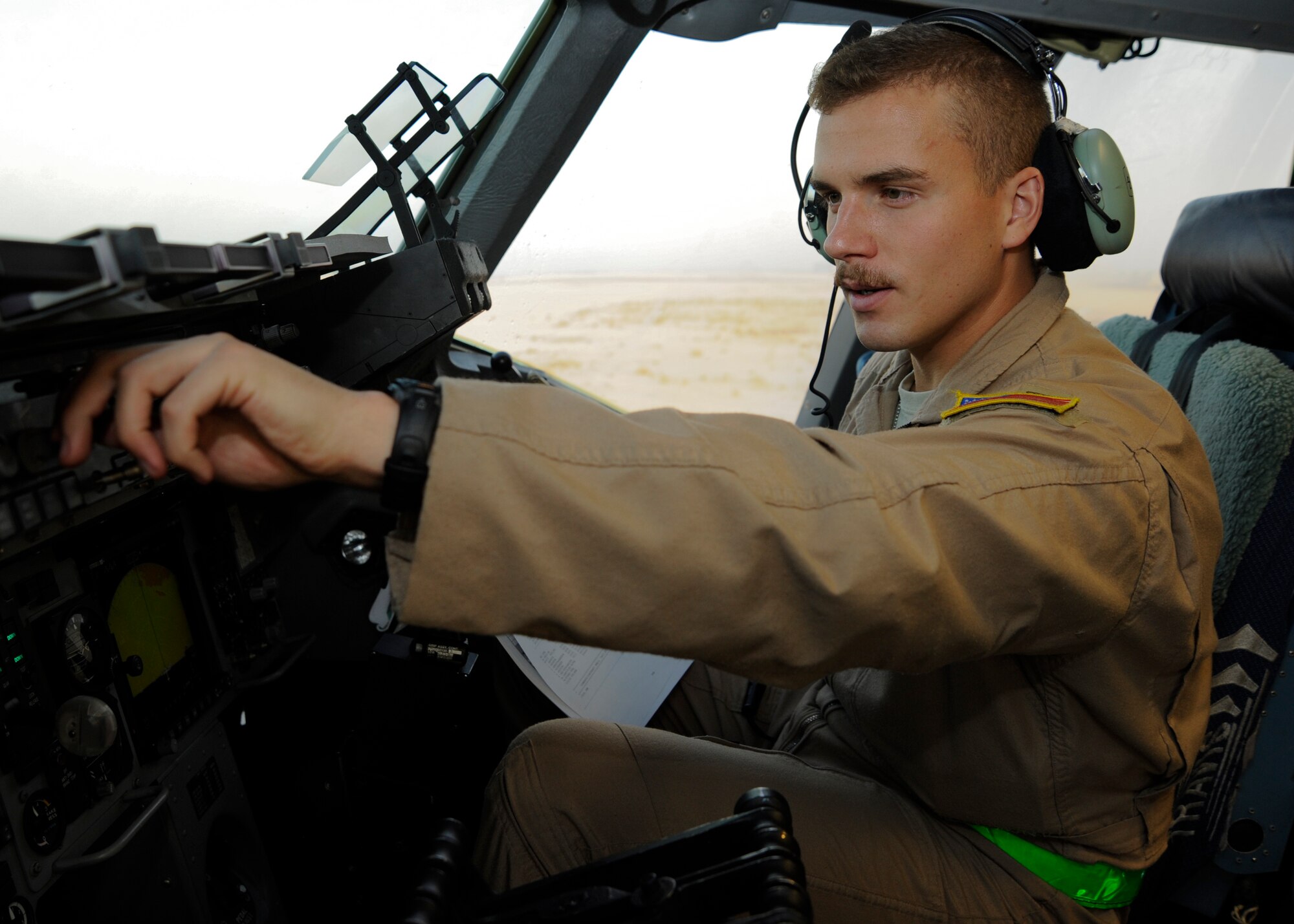 1st Lt. Cameron Horn performs a preflight check on the flight deck of a C-17 Globemaster III prior to a mission at the 379th Air Expeditionary Wing in Southwest Asia, Oct. 16, 2013. Capable of strategic delivery of troops and a broad range of cargo, the C-17 and its aircrews directly support operations within the U.S. Central Command area of responsibility.  Horn is an 816th Expeditionary Airlift Squadron co-pilot deployed from Joint Base Charleston, S.C., and a Pittsburgh native. 