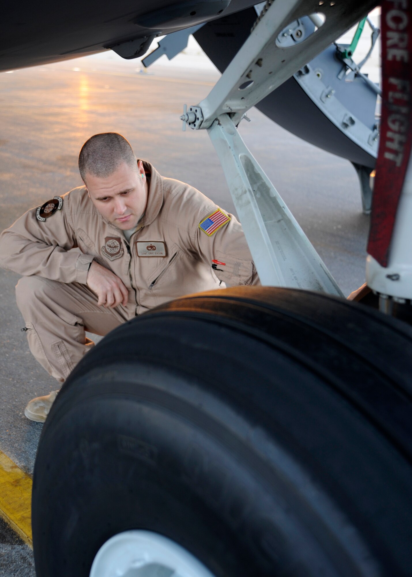 Staff Sgt. Eric Eason performs a preflight on the exterior of a C-17 Globemaster III prior to mission at the 379th Air Expeditionary Wing in Southwest Asia, Oct. 16, 2013. Typically C-17 aircrews consist of 3 pilots, 2 loadmasters and a flying crew chief. Eason is an 816th Expeditionary Airlift Squadron C-17 flying crew chief deployed from Joint Base Charleston, S.C., and hails from Felton, Del. (U.S. Air Force photo/Senior Airman Bahja J. Jones) 