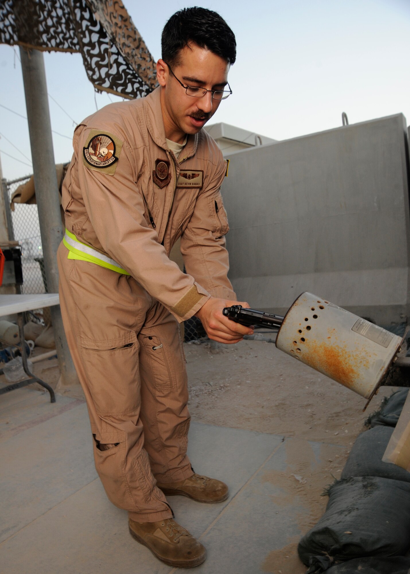 Staff Sgt. Kevin Banas clears an M-9 Beretta prior to a mission at the 379th Air Expeditionary Wing in Southwest Asia, Oct. 16, 2013. The members of the 816th Expeditionary Airlift Squadron, deployed from Joint Base Charleston, S.C., accomplish the air tasking order via passenger transport, ground and aerial delivery to keep deployed operations moving. Banas is a 816th Expeditionary Airlift Squadron C-17 Globemaster III loadmaster and hails from Taylor, Mich. (U.S. Air Force photo/Senior Airman Bahja J. Jones) 