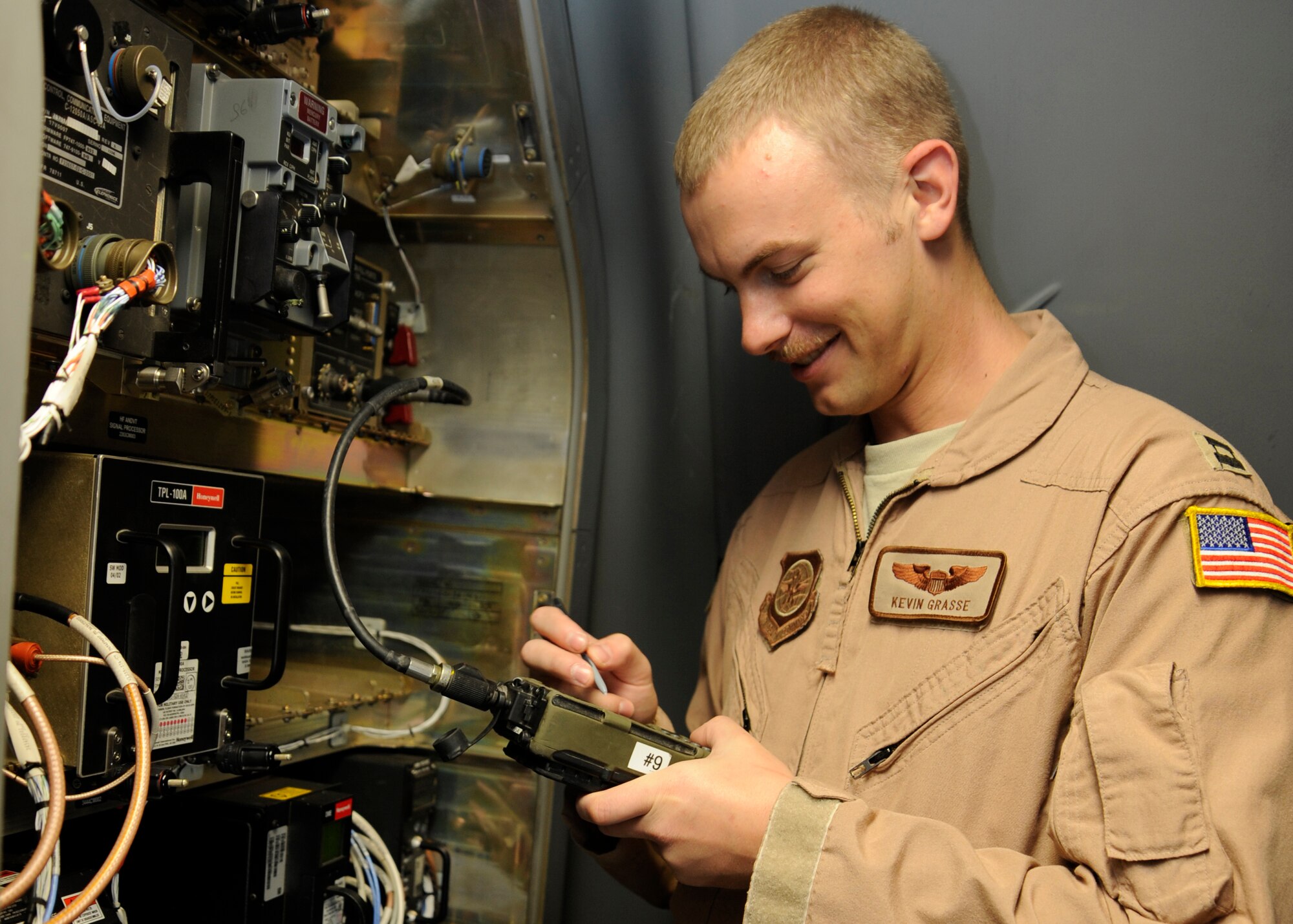 Capt. Kevin Grasse loads data into avionics equipment prior to a C-17 Globemaster III mission at the 379th Air Expeditionary Wing in Southwest Asia, Oct. 13, 2013. Capable of strategic delivery of troops and a broad range of cargo, the C-17 and its aircrews directly support operations within the U.S. Central Command area of responsibility.  Grasse is an 816th Expeditionary Airlift Squadron C-17 pilot deployed from Joint Base Charleston, S.C., and an Appleton, Wis., native. (U.S. Air Force photo/ Senior Airman Bahja J. Jones) 