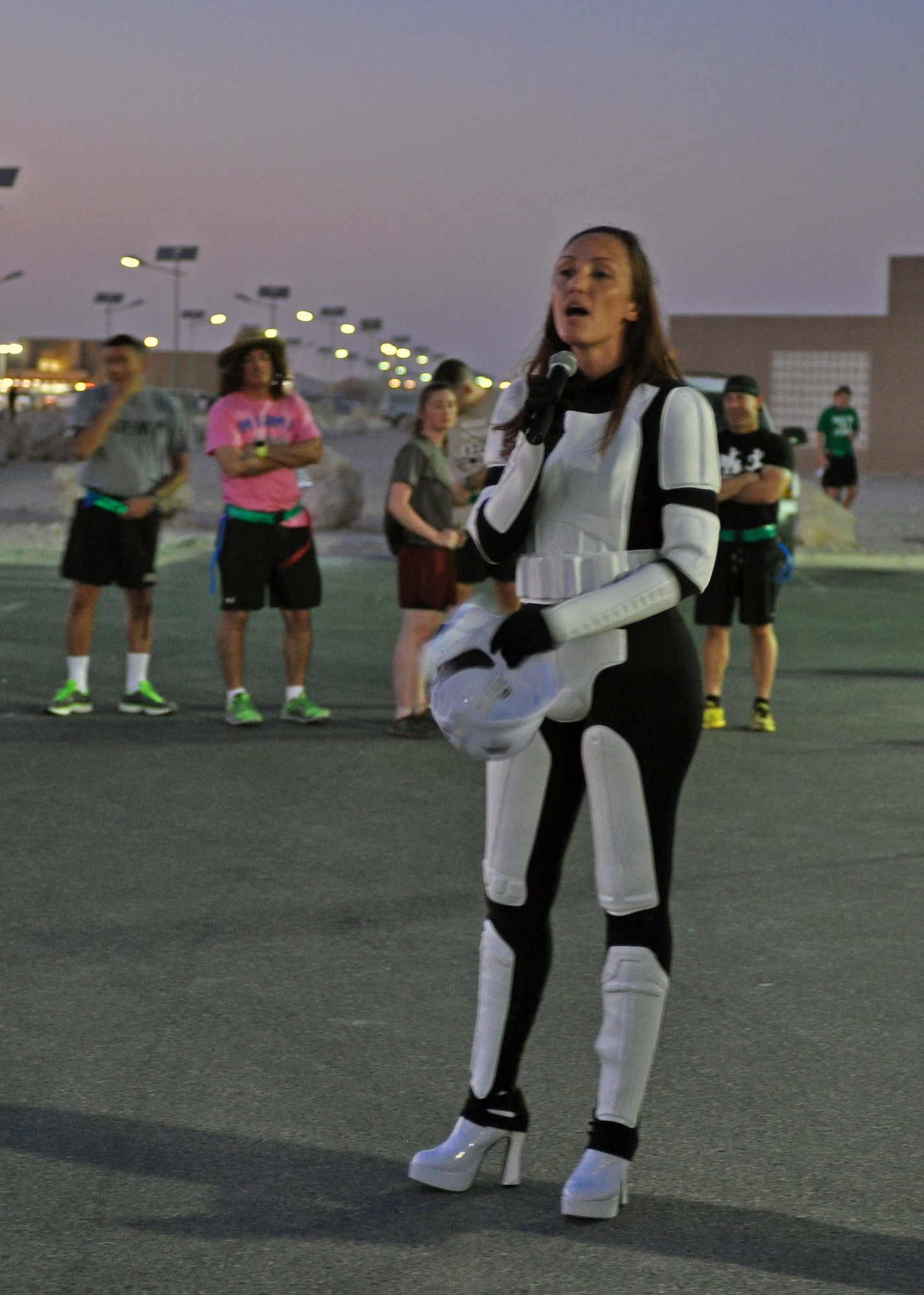 Tech. Sgt. Amber Anderson kicks off a zombie run with a few remarks at the 379th Air Expeditionary Wing in Southwest Asia, Oct. 12, 2013. The run was hosted by the Rising Six private organization to boost the morale of individuals on the base. Anderson is an 8th Expeditionary Air Mobility Squadron passenger service supervisor and the Rising Six vice president deployed from Ramstein Air Base, Germany, and a Pensacola, Fla., native. (U.S. Air Force photo/1st Lt. Susan Harrington)
