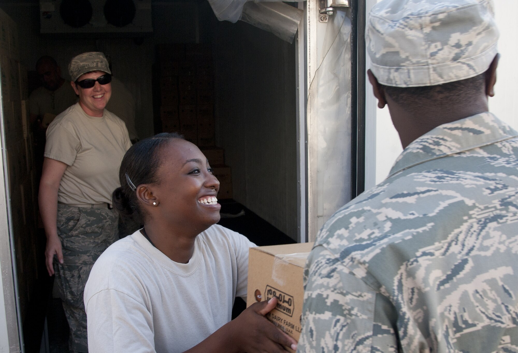 U.S. Air Force Staff Sgt. Padonda Ali, 380th Expeditionary Force Support Squadron food service specialist, takes a box of food to place into storage at an undisclosed location in Southwest Asia Oct. 8, 2013. Ali was part of a large EFSS team, who all come together to stock food when it is delivered. Ali calls Atlanta, Ga., home and is deployed from Beale Air Force Base, Calif. (U.S. Air Force photo by Staff Sgt. Jacob Morgan)