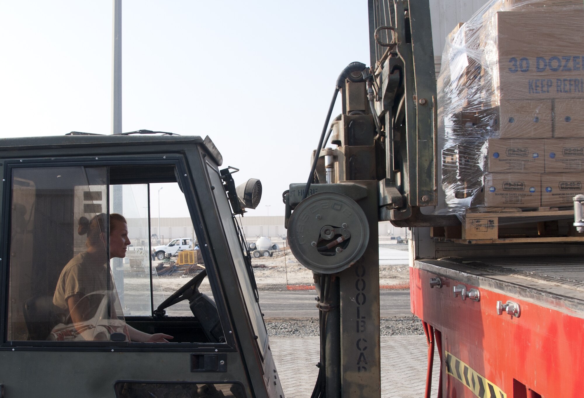 U.S. Air Force Staff Sgt. Kira Otero, 380th Expeditionary Force Support Squadron base water distributor, uses a forklift to off-load a food truck at an undisclosed location in Southwest Asia Oct. 8, 2013. Otero was part of a large EFSS team, who all come together to stock food when it is delivered. Otero calls Sedalia, Mo., home, and is deployed from Whiteman Air Force Base, Mo. (U.S. Air Force photo by Staff Sgt. Jacob Morgan) 