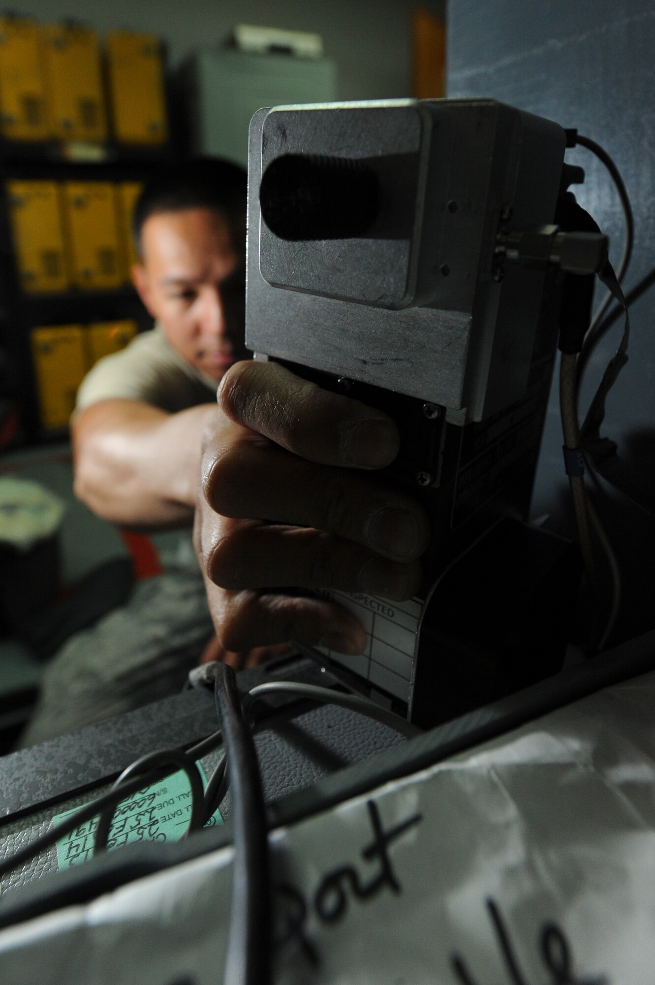 Senior Airman Francis Nacapui, 99th Expeditionary Reconnaissance Squadron physiological support detachment technician, performs a 90-day inspection on a survival radio at an undisclosed location in Southwest Asia Oct. 7, 2013. PSD Airmen manage and pack the survival kit used by U-2 Dragon Lady pilots. Nacapui is native to Buena Park, Calif., and is deployed from Beale Air Force Base, Calif. (U.S. Air Force photo by Staff Sgt. Joshua J. Garcia) 