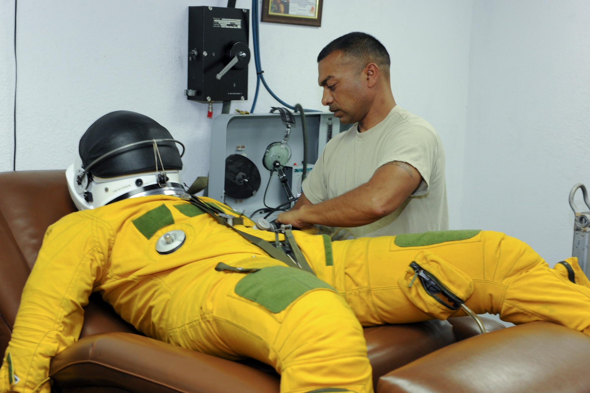U.S. Air Force Master Sgt. Mandeep Johal, 99th Expeditionary Reconnaissance Squadron physiological support detachment supervisor, fills a pressure suit with air to check for leaks at an undisclosed location in Southwest Asia Oct. 7, 2013. Johal said the suit is the backup system to the pressurization system on the aircraft. If the cabin loses pressure and the pilot has to eject while at altitude, the suit will keep the pilots safe. Johal is native to Sacramento, Calif., and is deployed from Beale Air Force Base, Calif. (U.S. Air Force photo by Staff Sgt. Joshua J. Garcia) 