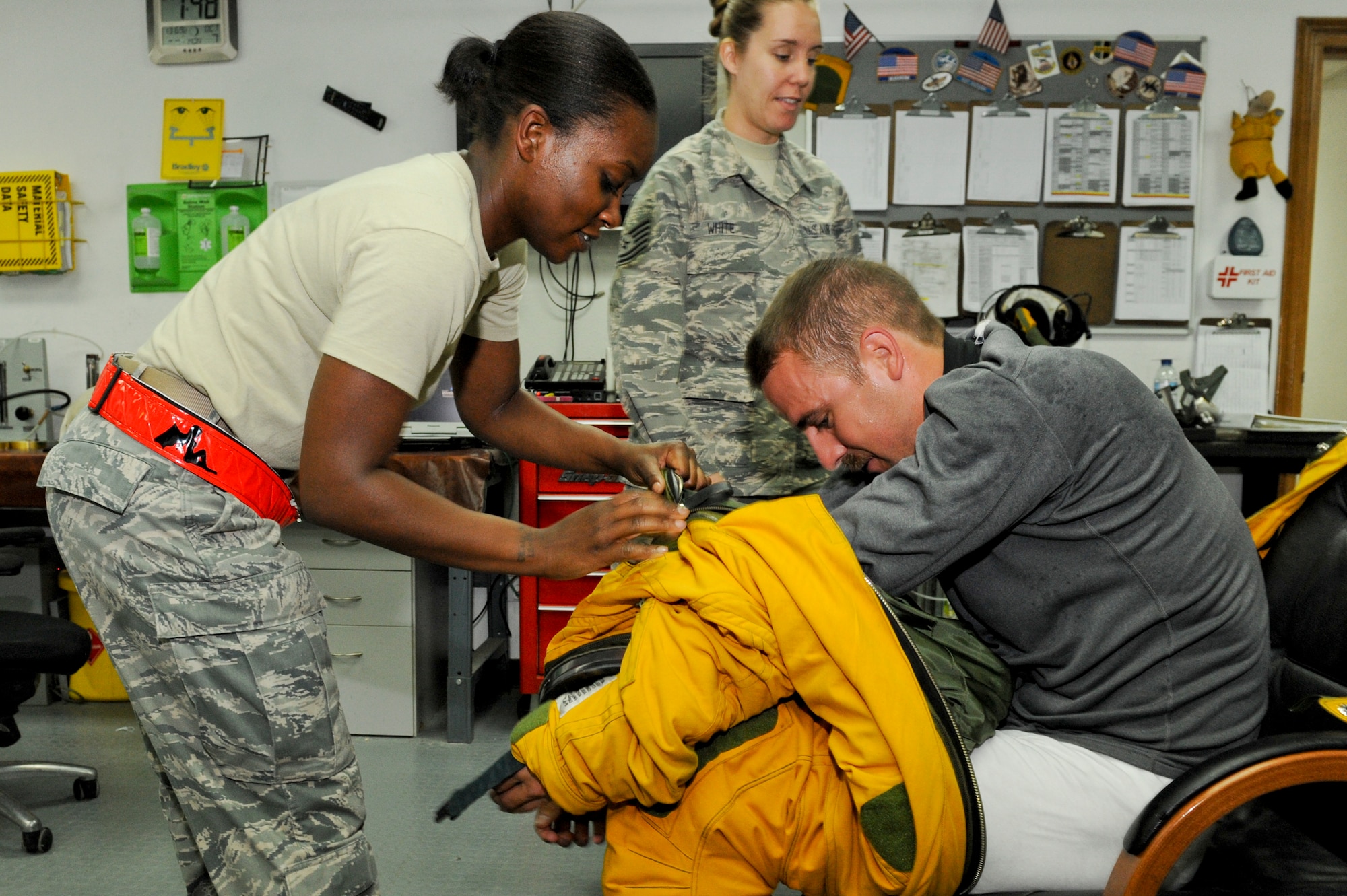 U.S. Staff Sgt. Jasmine Chambers, 99th Expeditionary Reconnaissance Squadron physiological support detachment technician, helps a U-2 Dragon Lady pilot out of his fully pressurized body suit after a flight at an undisclosed location in Southwest Asia, Oct. 7, 2013. The moment the pilot dons the suit PSD Airmen manage the pilot’s actions prior to takeoff and after the flight. Chambers is native to Charlotte, N.C., and is deployed from Beale Air Force Base, Calif. (U.S. Air Force photo by Staff Sgt. Joshua J. Garcia) 