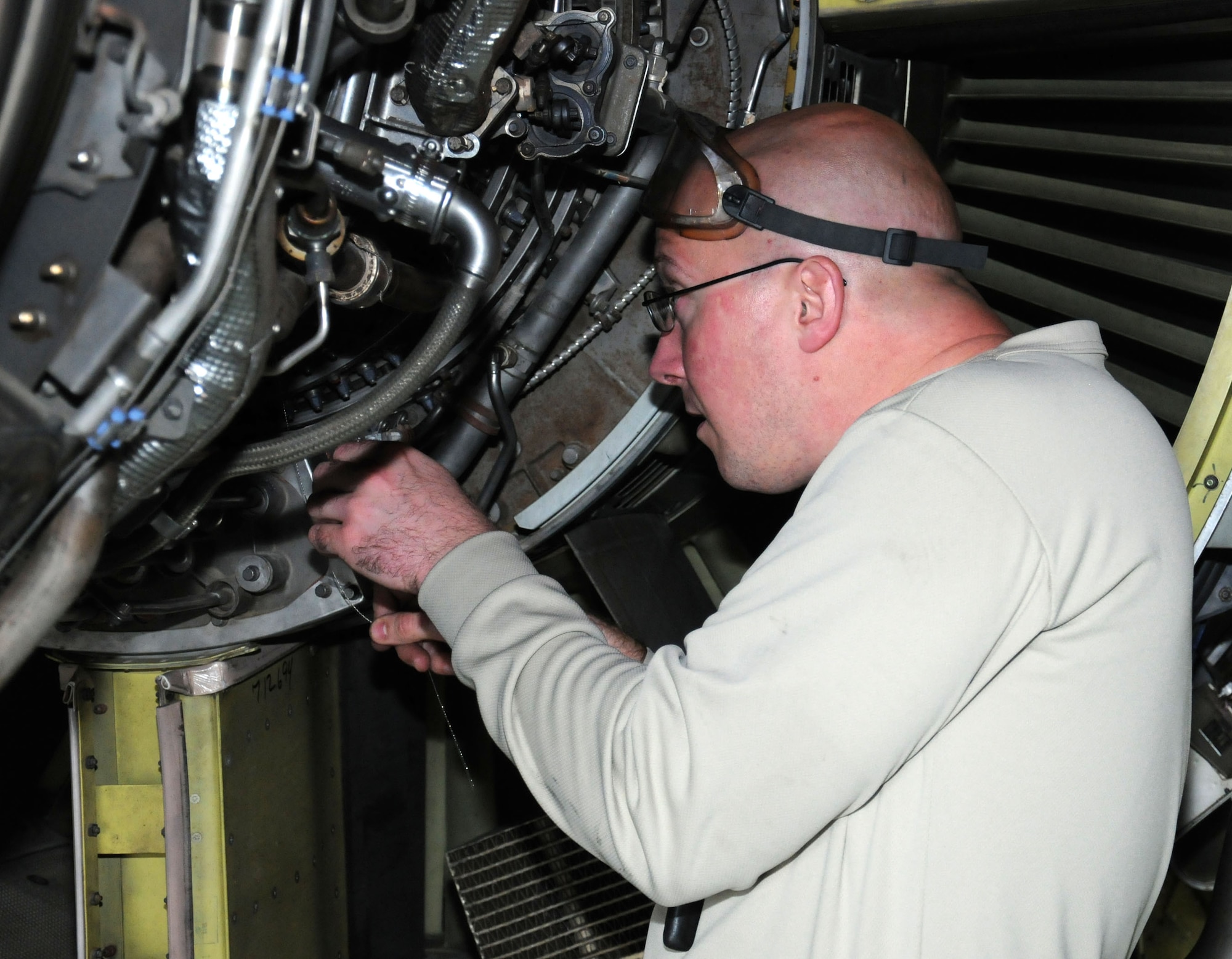 U.S. Air Force Staff Sgt. David Manning, 100th Maintenance Squadron inspection propulsion craftsman from Poultney, Vt., ensures the length of a safety cable is correct Oct. 8, 2013, on RAF Mildenhall, England. Manning checks the cable prior to its installation on the borescope access port. (U.S. Air Force photo by Gina Randall/Released)