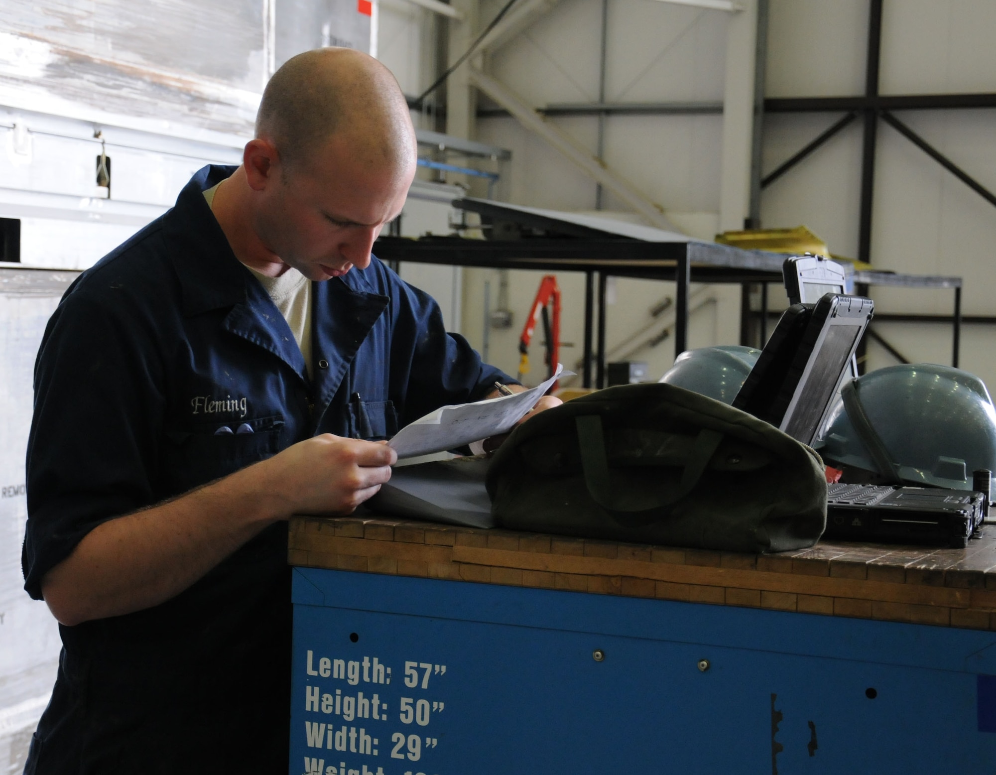 U.S. Air Force Staff Sgt. Jason Fleming, 100th Maintenance Squadron aircraft structural maintenance craftsman from Fort Oglethorpe, Ga., reviews a list of tasks for items requiring sheet metal repair Oct. 8, 2013, on RAF Mildenhall, England. The 100th MXS inspections shop also supports other 100th MXS shops including the fuel cell, hydro, and electrical and environmental shops. (U.S. Air Force photo by Gina Randall/Released)