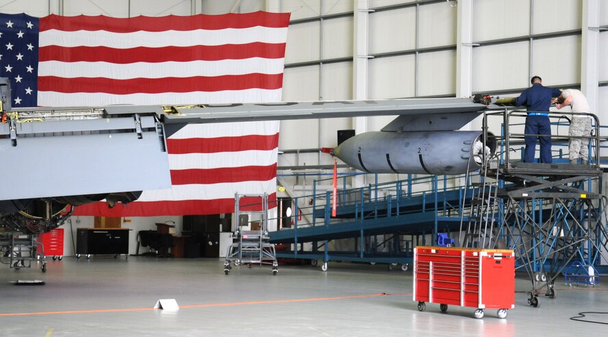 Service members from the 100th Maintenance Squadron work on a KC-135 Stratotanker Oct. 8, 2013, in Hangar 814 on RAF Mildenhall, England. The 100th MXS works with other squadrons including the 100th Aircraft Maintenance Squadron, 95th Reconnaissance Squadron and 352nd  Special Operations Group. (U.S. Air Force photo by Gina Randall/Released)