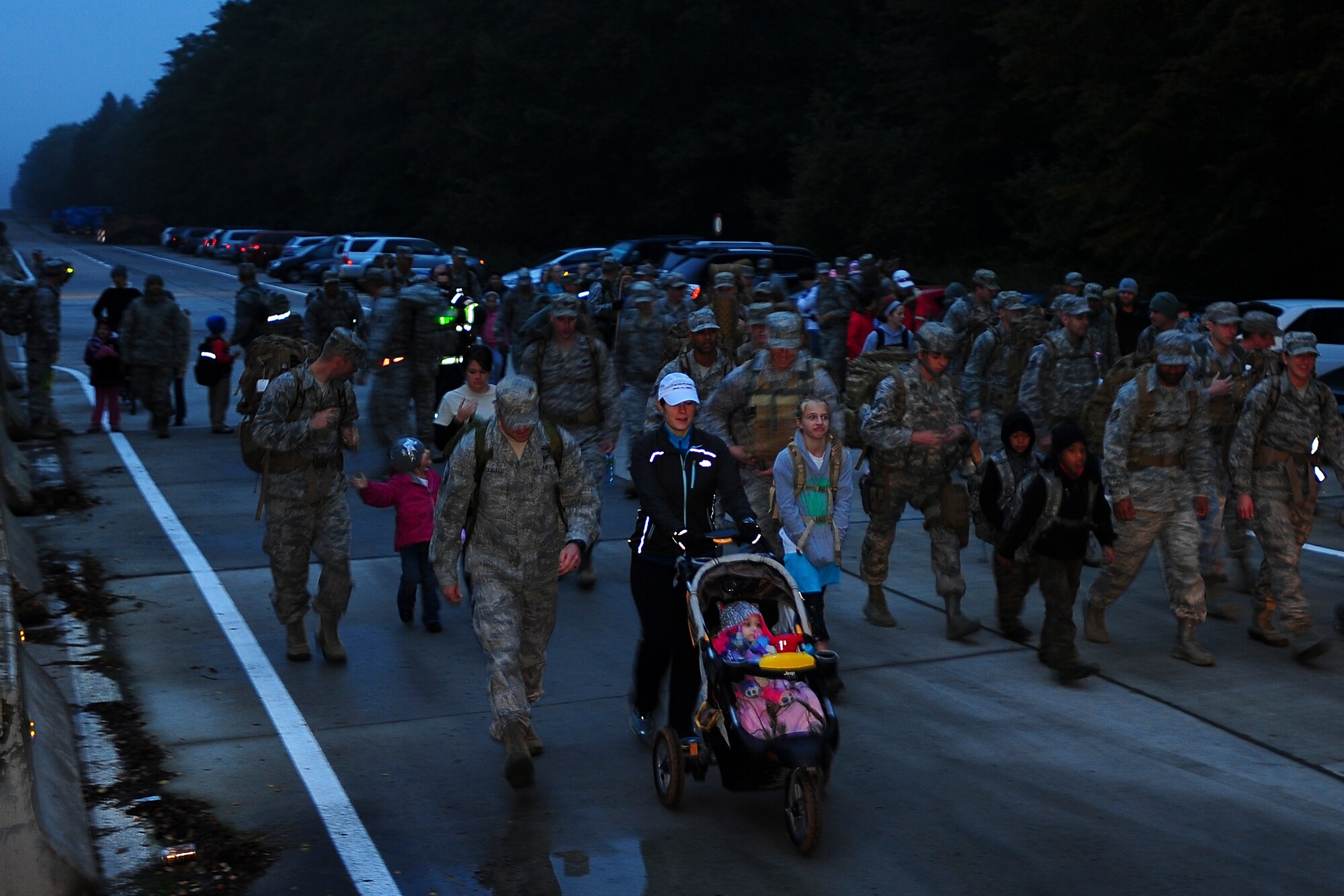 Approximately 75 members of the 435th Contingency Response Group conducted a 5 kilometer weighted-ruck march, Oct. 11, 2013, Ramstein Air Base. The squadron rucks every Friday morning, year round, but this was the first time family members accompanied the Airmen. Family members were able to experience the 435th CRG does to ensure readiness. Air Force fitness is essential to mission readiness and this march helps Airmen get physically prepared for a deployed environment. The 435th CRG plans to continue to do this for as long as possible in any weather condition, anytime of the year. (U.S. Air Force Photo/Airman 1st Class Michael Stuart)