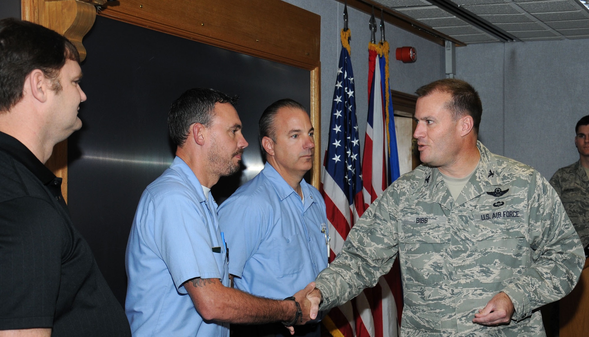 U.S. Air Force Col. Kenneth T. Bibb Jr., right, 100th Air Refueling Wing commander, congratulates David Lawrence, second from right, 100th Force Support Squadron lodging maintenance supervisor from San Jose, Calif.; Paul Jarred, second from left, 100th FSS lodging maintenance worker from Mundford, Norfolk, and Tod Shady, left, 352nd Special Operations Maintenance Squadron contract maintenance team site lead from Maquoketa, Iowa, Oct. 16, 2013, on RAF Mildenhall, England. Bibb recognized the men for their quick thinking, which potentially saved their coworker’s life. Shady had noticed a coworker hadn’t shown up for work and relayed his concern to the lodging staff. When there was no answer at the coworker’s door, these three gentlemen entered the premises to find the coworker unconscious and having suffered a major stoke. The coworker is now recovering thanks to their efforts to find and help him. (U.S. Air Force photo by Gina Randall/Released) 