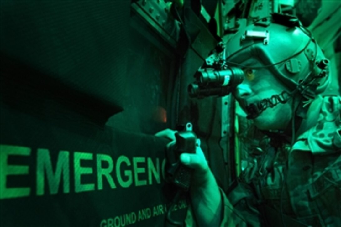 U.S. Air Force Senior Airman Larry Webster uses night vision goggles to scan for potential threats using after completing a cargo airdrop in the Ghazni Province of Afghanistan on Oct. 7, 2013.   Webster is a loadmaster from the 774th Expeditionary Airlift Squadron and is deployed from Little Rock Air Force Base, Ark.  