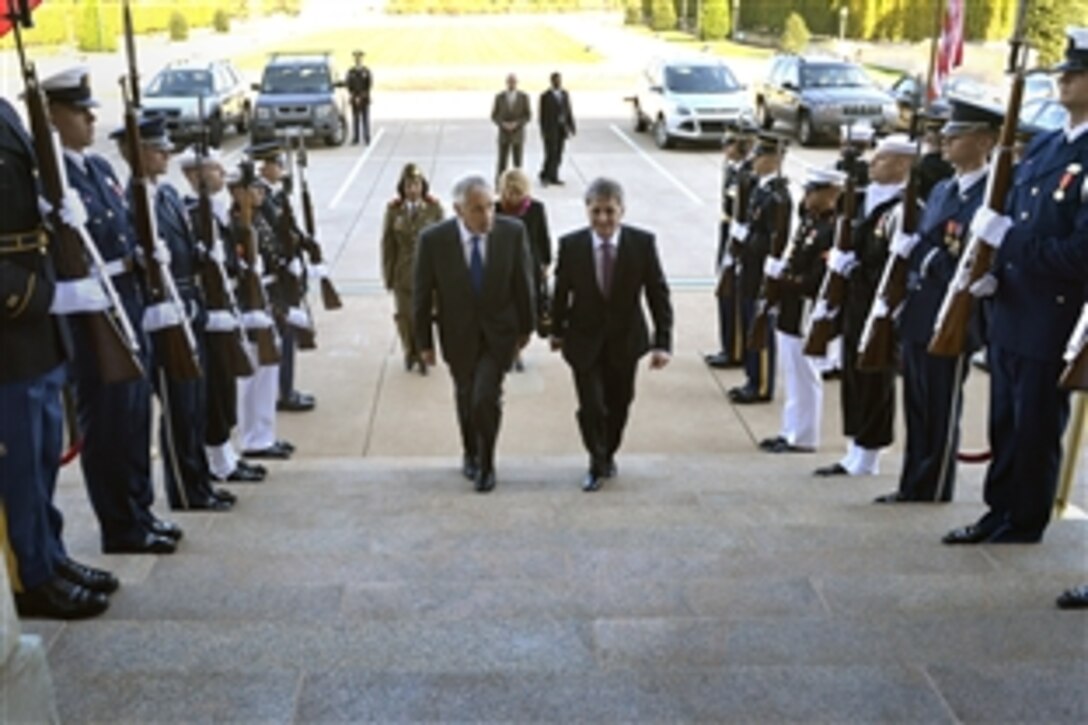 U.S. Defense Secretary Chuck Hagel, center left, hosts an honor cordon to welcome Romania's Defense Minister Mircea Dusa to the Pentagon, Oct. 18, 2013. The two defense leaders met to discuss issues of mutual importance.