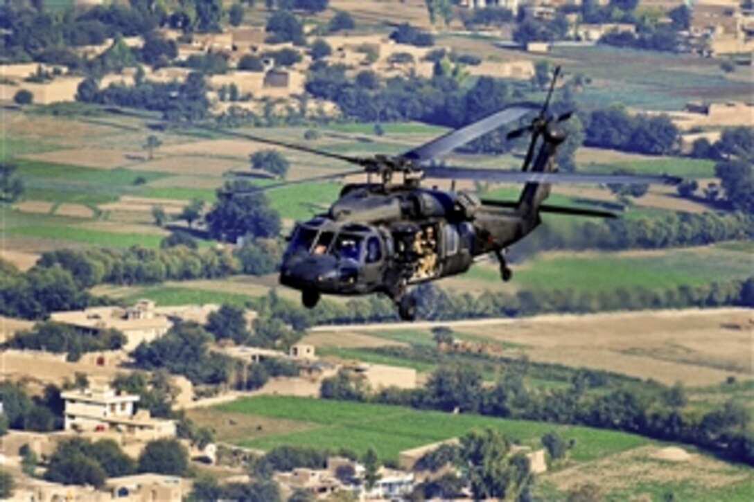 A UH-60L Black Hawk helicopter conducts a mission to move personnel over Nangarhar province, Afghanistan, Oct. 11, 2013. The helicopter crew is assigned to the Massachusetts National Guard, attached to the 10th Combat Aviation Brigade.