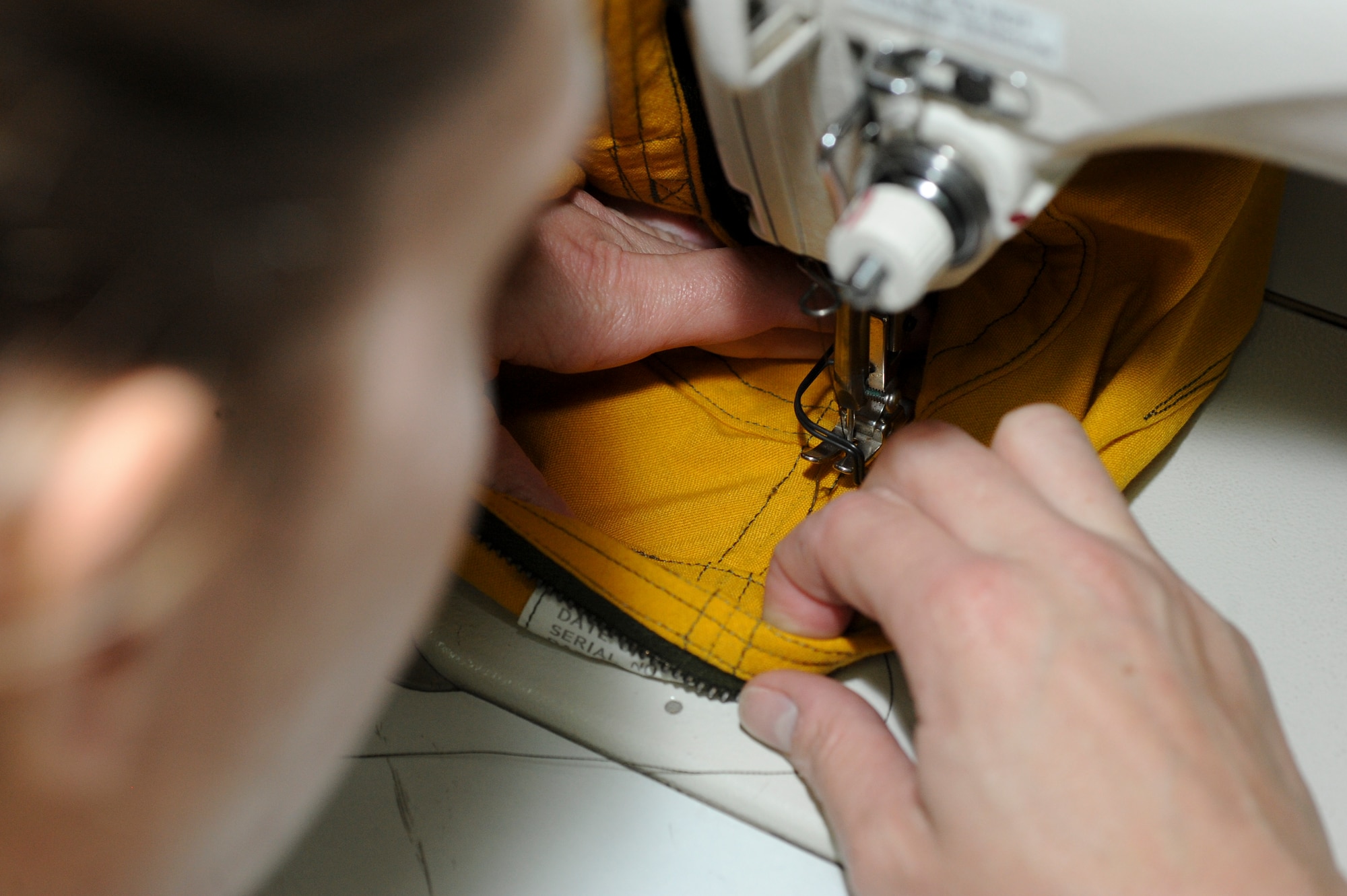 U.S. Tech. Amanda White, 99th Expeditionary Reconnaissance Squadron physiological support detachment technician, fixes a seam on a U-2 Dragon Lady pilot’s pressure suit at an undisclosed location in Southwest Asia Oct. 7, 2013. PSD Airmen maintains every aspect of the suit once it is received from the manufacturer. They fix seams and perform preventive maintenance on the suits. White is native to Indianapolis, Ind., and is deployed from Beale Air Force Base, Calif. (U.S. Air Force photo by Staff Sgt. Joshua J. Garcia)  