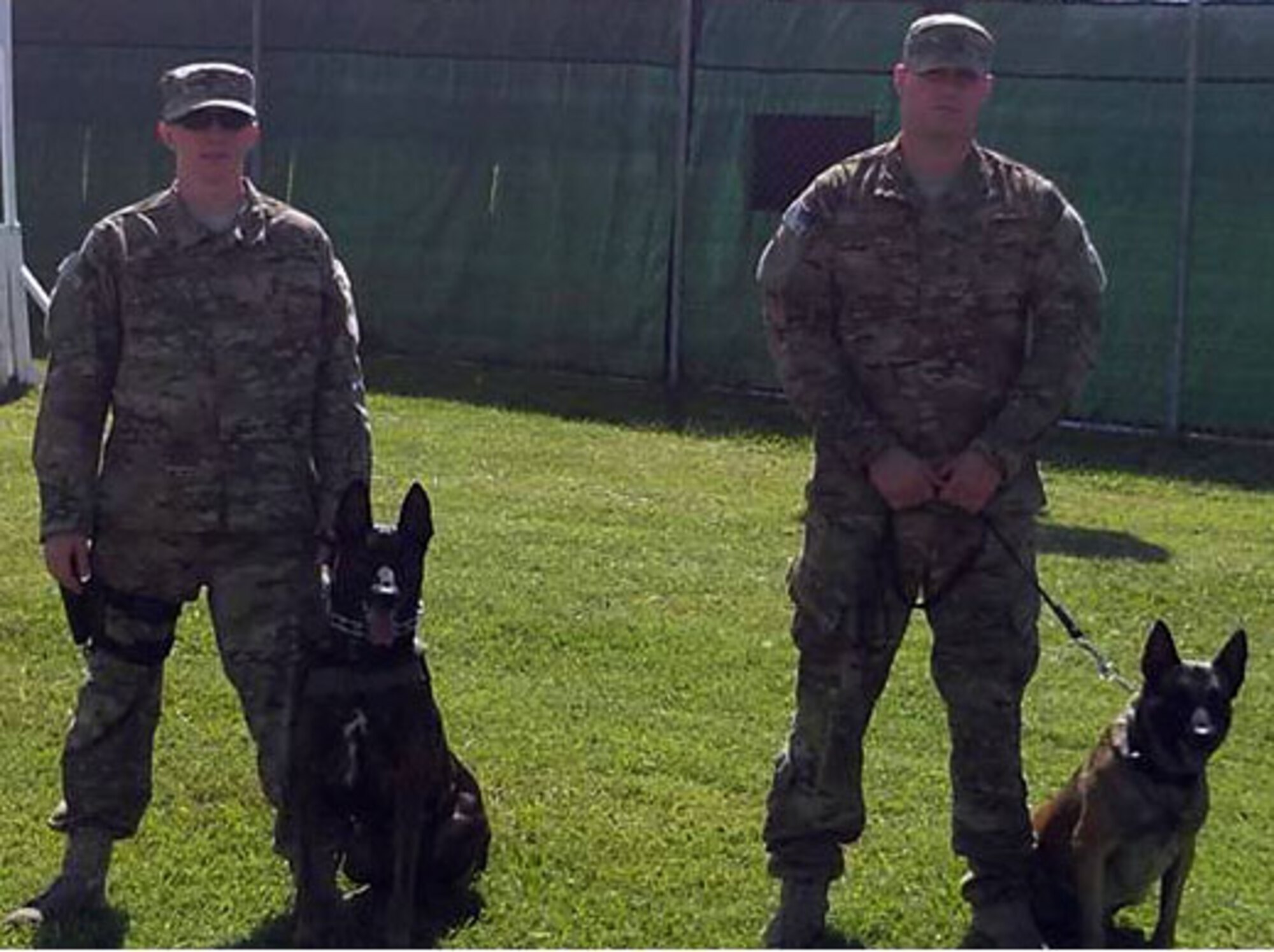 U.S. Air Force Staff Sgt. Matthew Liimakka and U.S. Air Force Staff Sgt. Ryan Kelley are part of a uniquely diverse team within the Joint Task Force-Bravo JSF K-9 unit.  The members of the Joint Task Force-Bravo Joint Security Forces K-9 unit represent three branches of service.  The K-9 unit consists of members of the U.S. Army, the U.S. Navy, and the U.S. Air Force.  (Photo by U.S. Army Sgt. Dionny Betancourt)