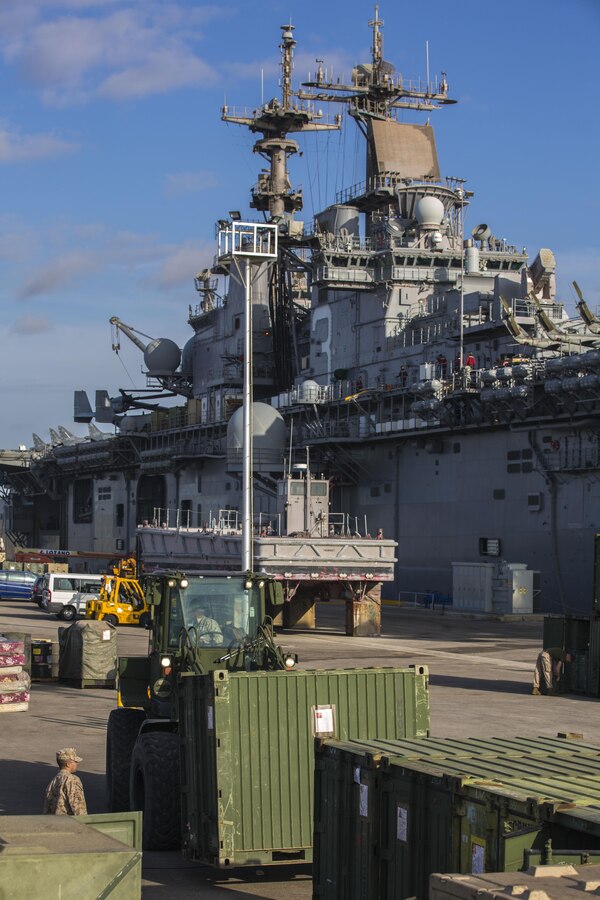 Shipping containers are transported after being inspected by U.S. Customs agents during the 26th Marine Expeditionary Unit’s (MEU) wash down in Naval Station Rota, Spain, Oct. 19, 2013. The 26th MEU is a Marine Air-Ground Task Force forward-deployed to the U.S. 6th Fleet area of responsibility aboard the Kearsarge Amphibious Ready Group serving as a sea-based, expeditionary crisis response force capable of conducting amphibious operations across the full range of military operations.  (U.S. Marine Corps photo by Sgt. Christopher Q. Stone, 26th MEU Combat Camera/Released) 