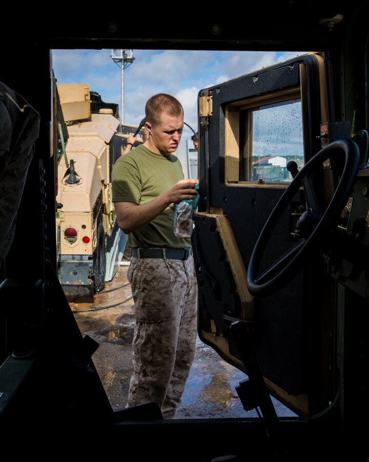 A U.S. Marine assigned to 26th Marine Expeditionary Unit (MEU) cleans the door of his Humvee prior to being inspected by U.S. Customs agents during the 26th MEU’s wash down in Naval Station Rota, Spain, Oct. 19, 2013. The 26th MEU is a Marine Air-Ground Task Force forward-deployed to the U.S. 6th Fleet areas of responsibility aboard the Kearsarge Amphibious Ready Group serving as a sea-based, expeditionary crisis response force capable of conducting amphibious operations across the full range of military operations.  (U.S. Marine Corps photo by Sgt. Christopher Q. Stone, 26th MEU Combat Camera/Released) 